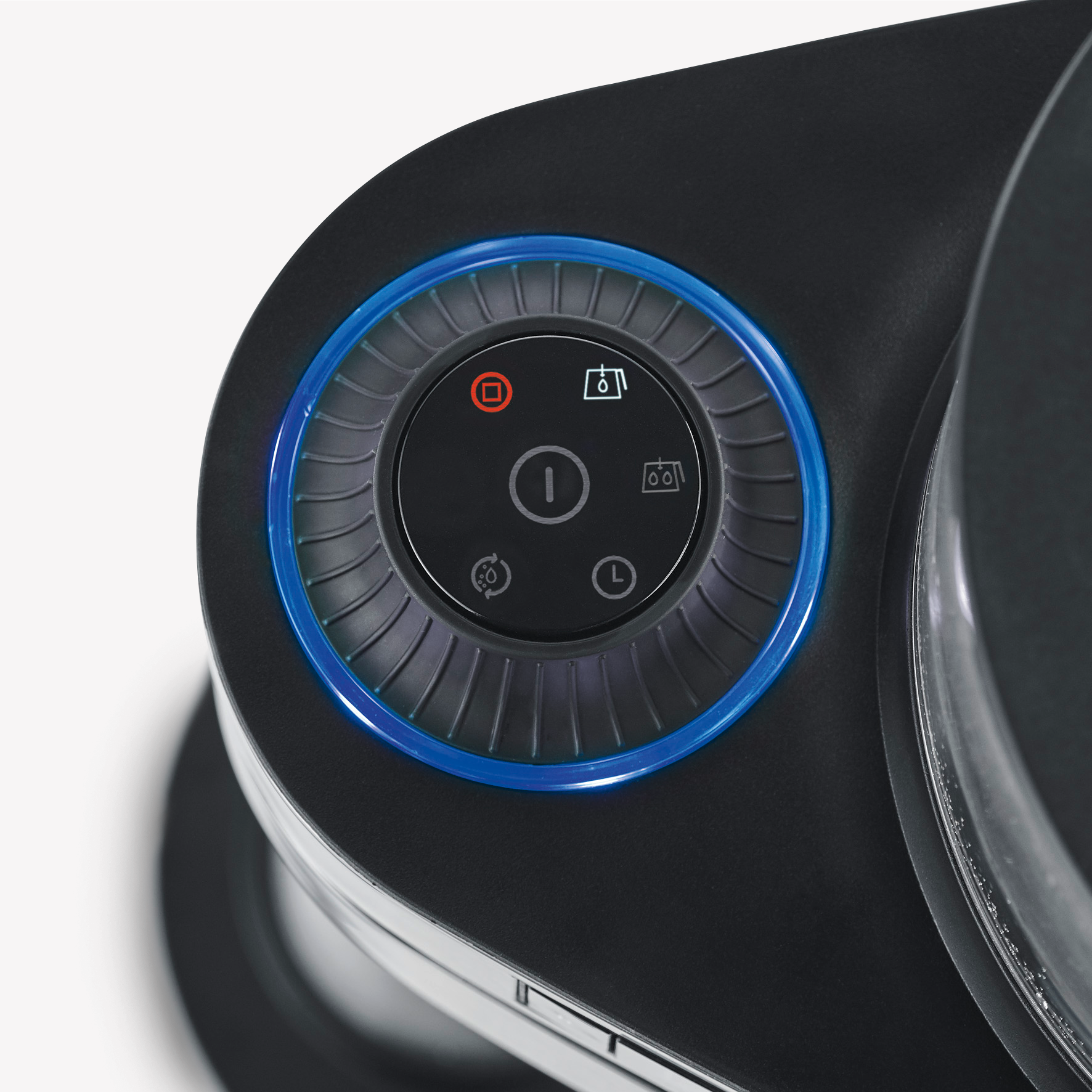 Close up of a black coffee machine control panel with a blue illuminated ring.