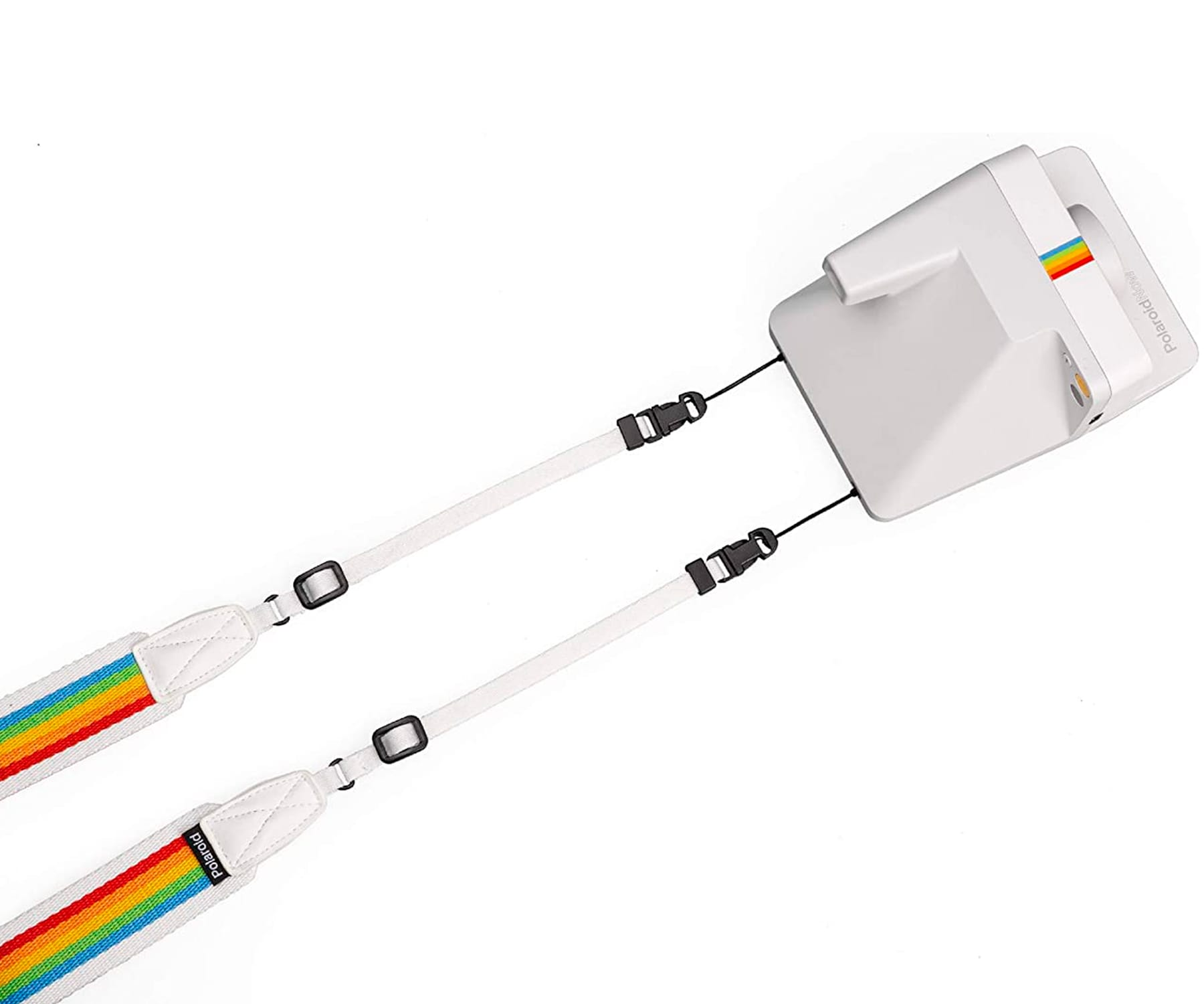 Aparat Polaroid, biała obudowa. Białe paski z tęczowymi paskami. Czarne zapięcia.