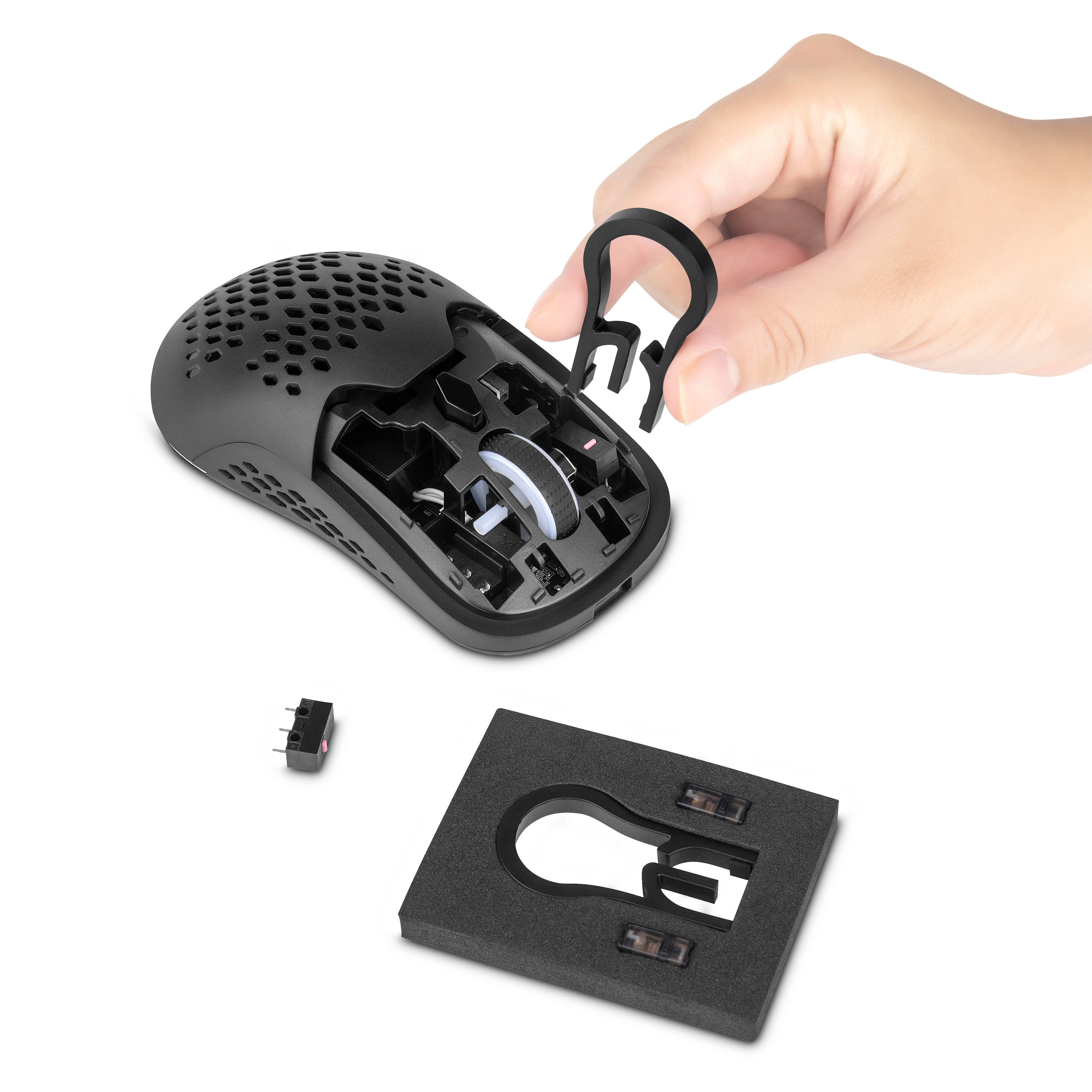 Mano quitando el botón del ratón de un ratón gaming negro, mostrando componentes internos.