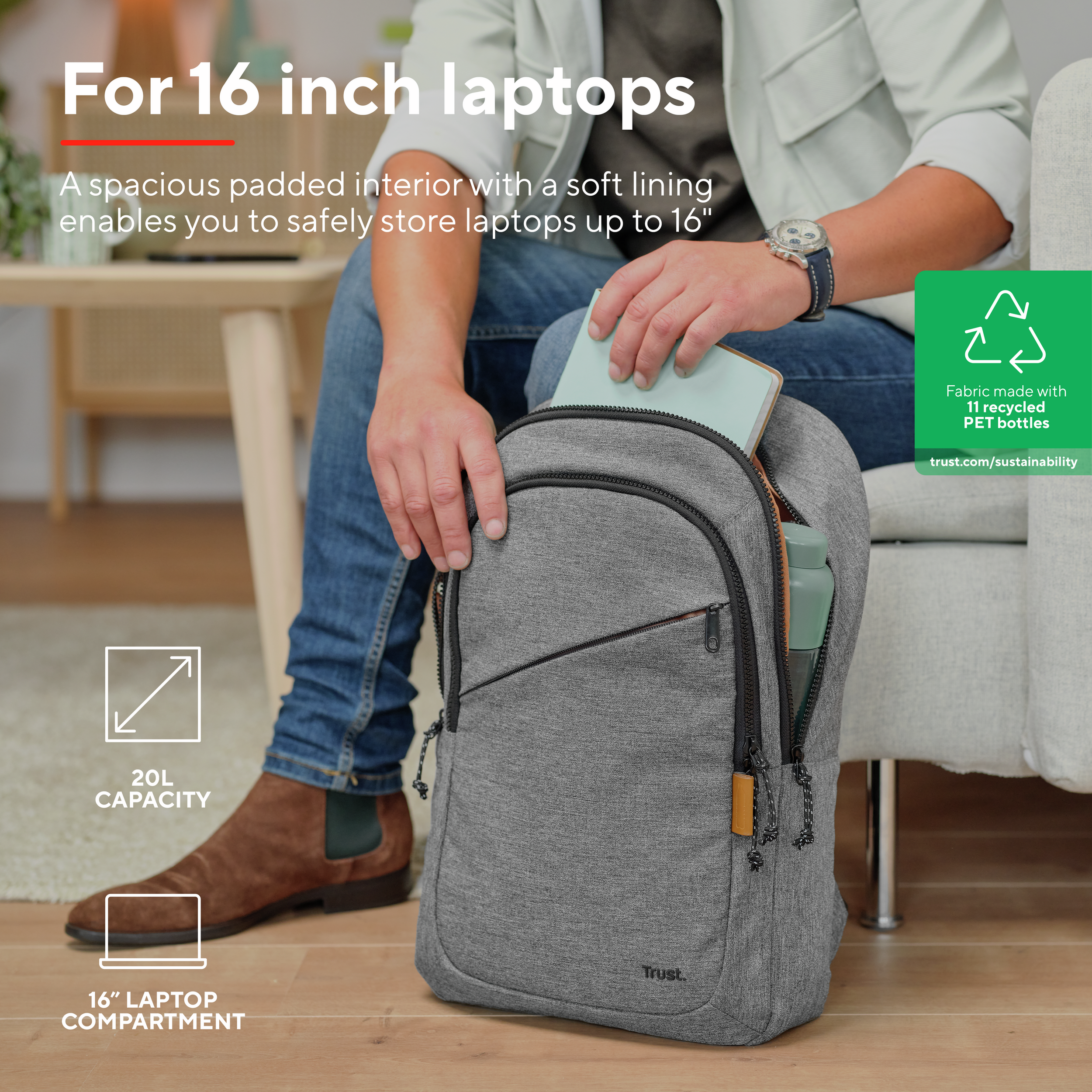 Person holding a grey backpack with a laptop and water bottle inside; white background.