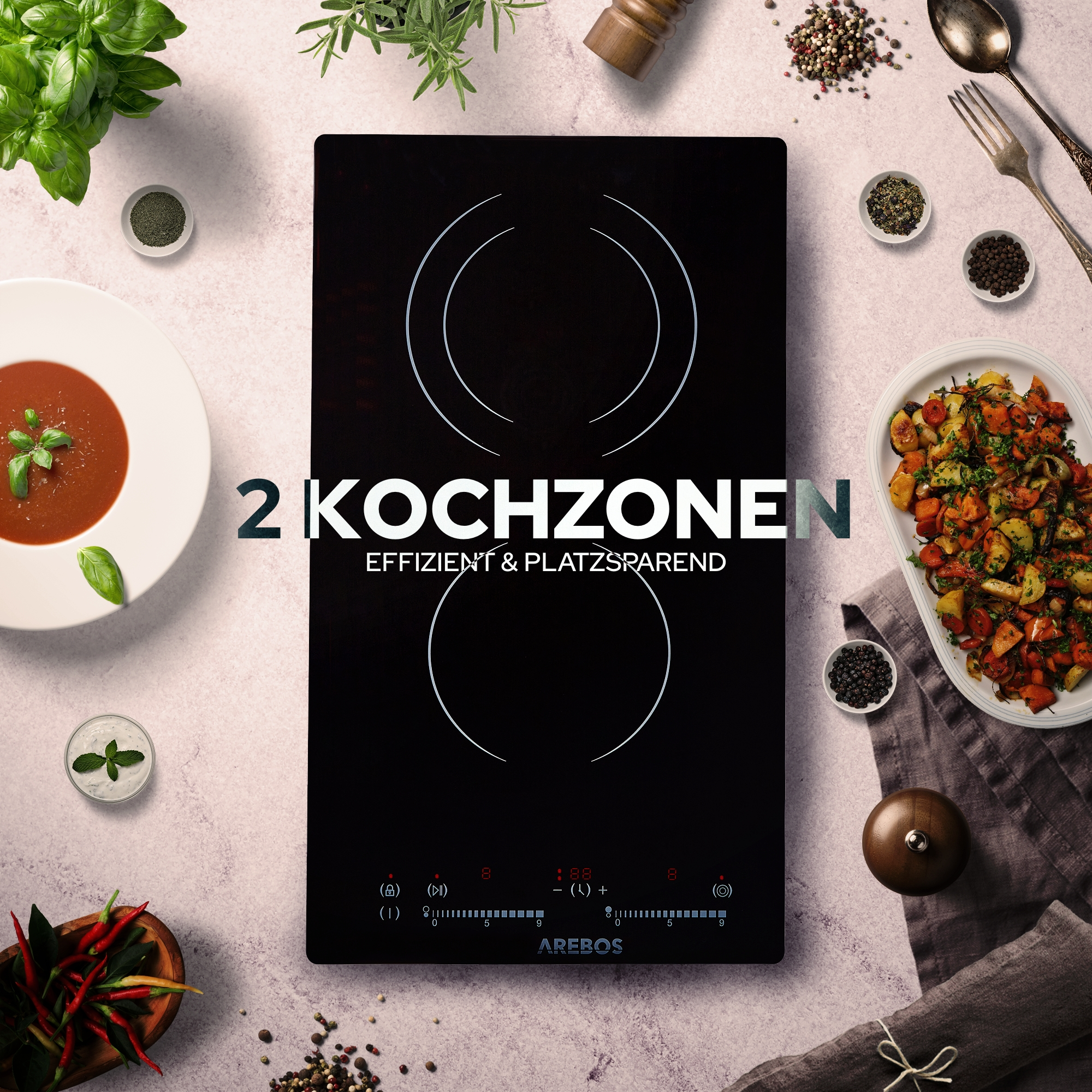 Induktionskochfeld mit zwei Kochzonen und Essen auf Tellern. Text: 2 KOCHZONEN. Effizient & platzsparend.