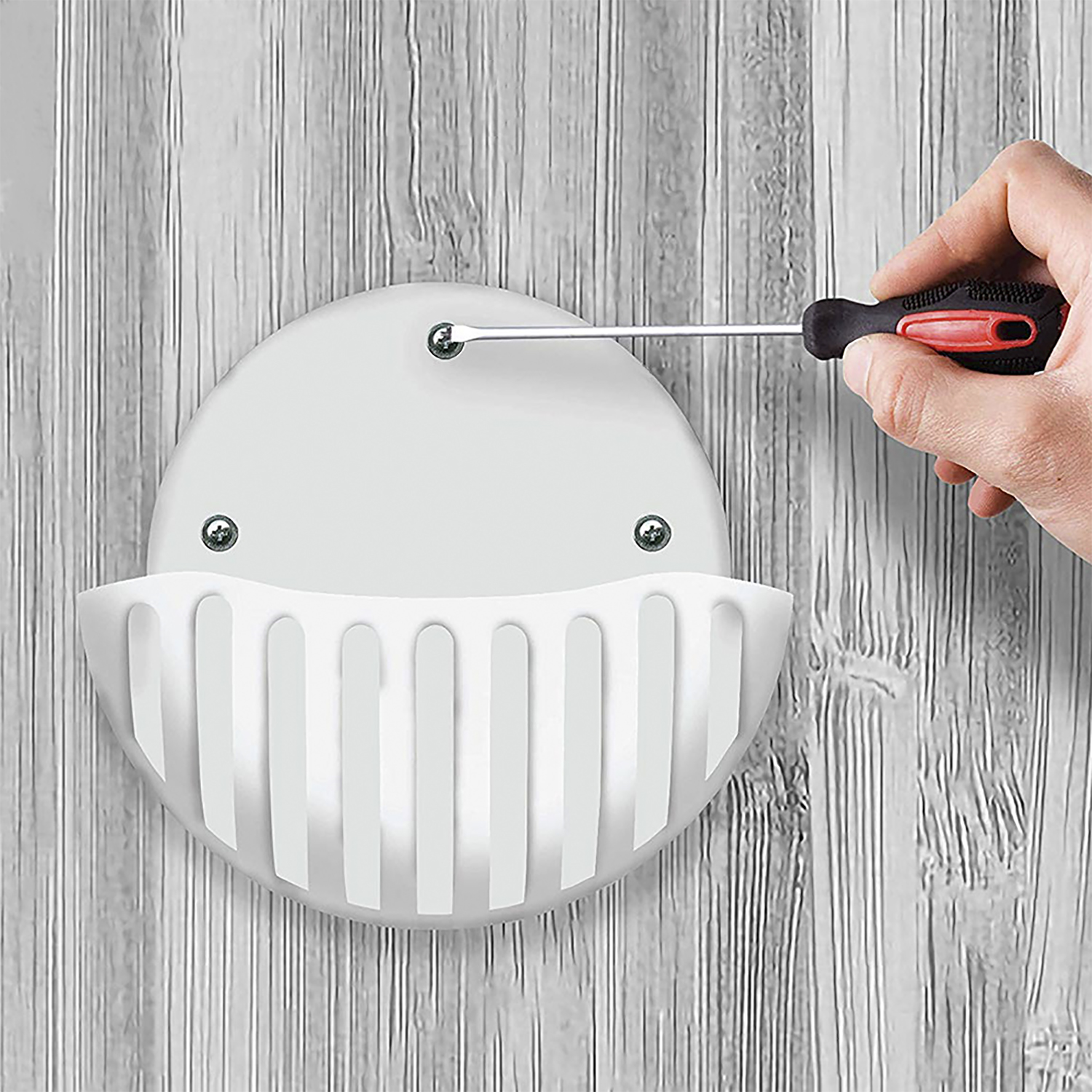 Un muro bianco con un supporto bianco installato con un cacciavite.