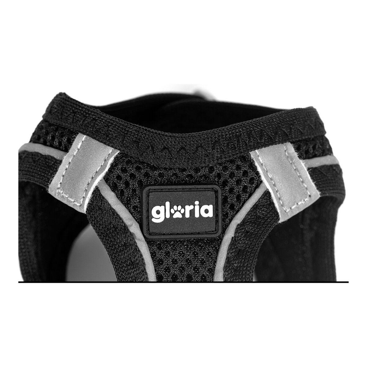 Schwarzes Hundegeschirr mit reflektierenden Streifen und dem Wort 'gloria' in einer weißen Box.
