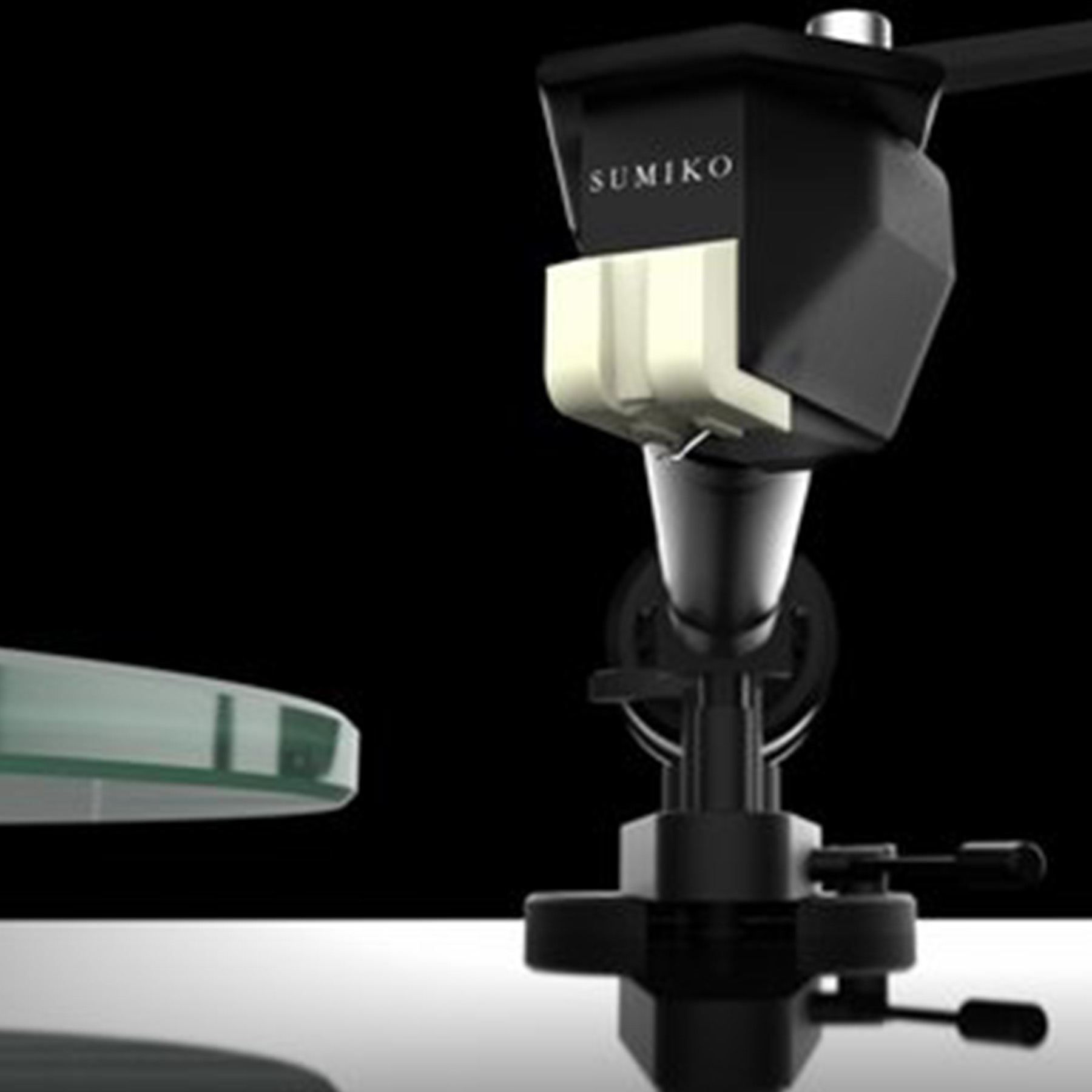 Close-up of a black record player head. The Sumiko brand is visible.