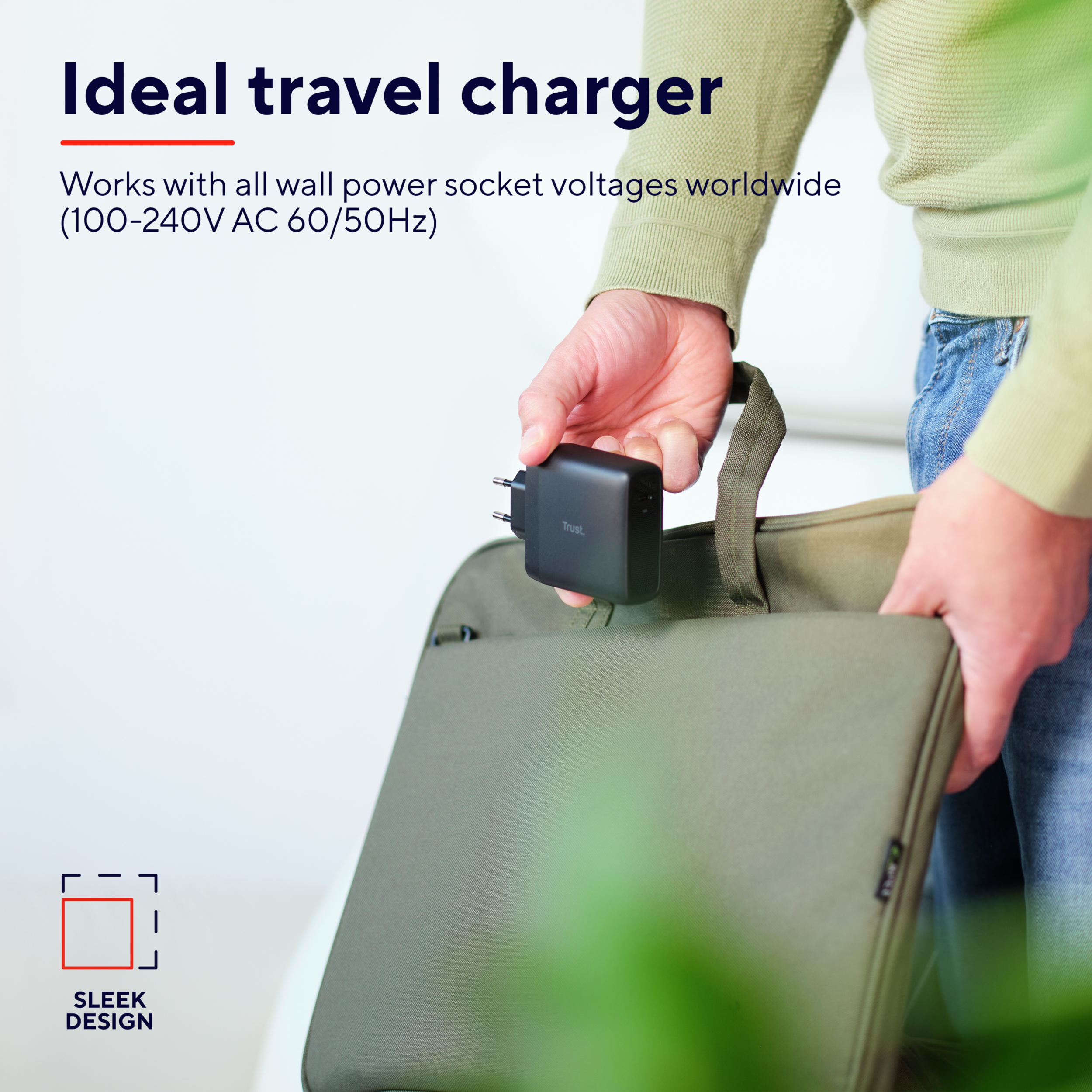 A person holding a black travel charger with a plug, next to a green bag. The words 'Sleek Design' are present.
