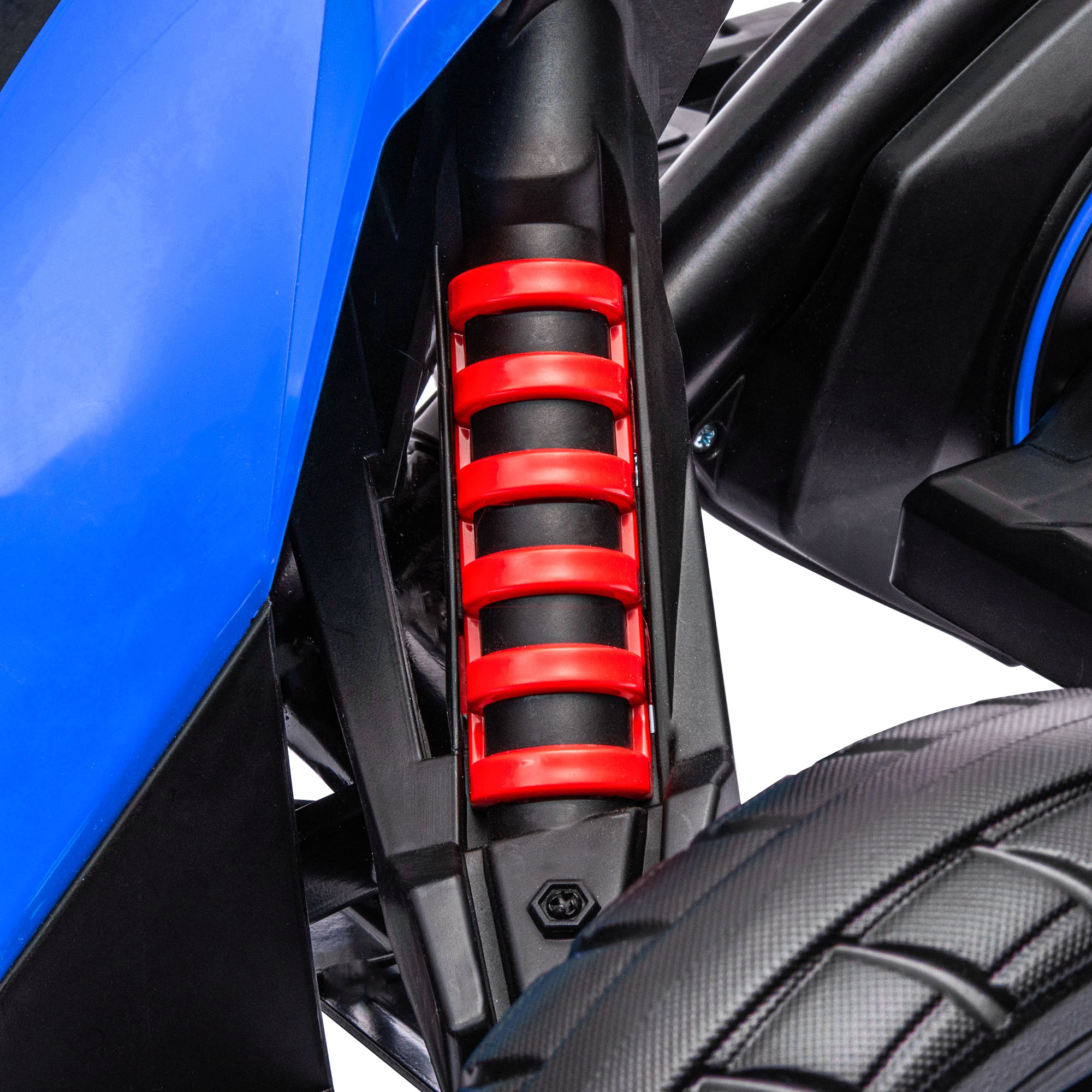 Primer plano de la suspensión de un coche negro y azul. El muelle de la suspensión es rojo.