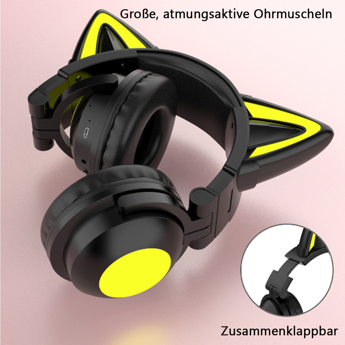 Schwarze Kopfhörer mit gelben Katzenohren auf rosa Oberfläche. Die Kopfhörer sind faltbar.