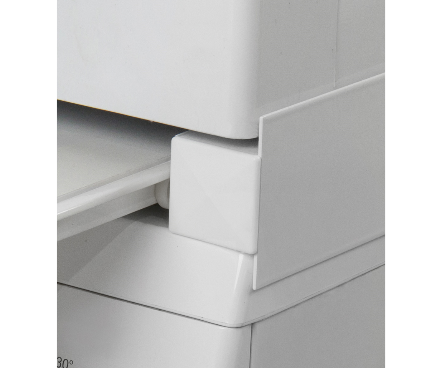 White plastic corner of a structure. The image is a close up shot, white background.