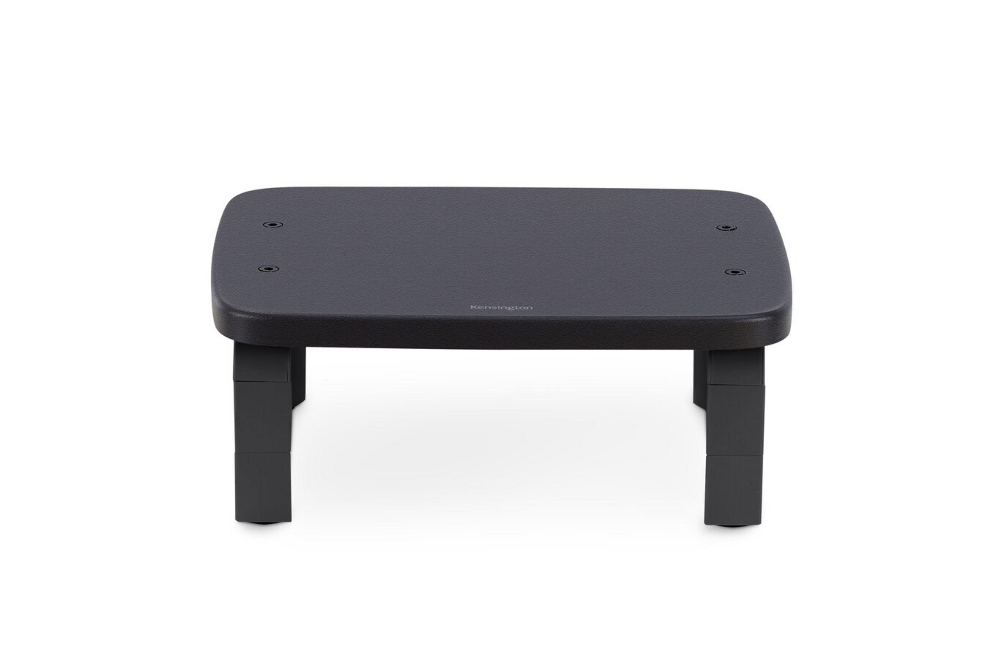 Un support d'écran noir est isolé sur blanc. Il a des pieds et une surface plane.