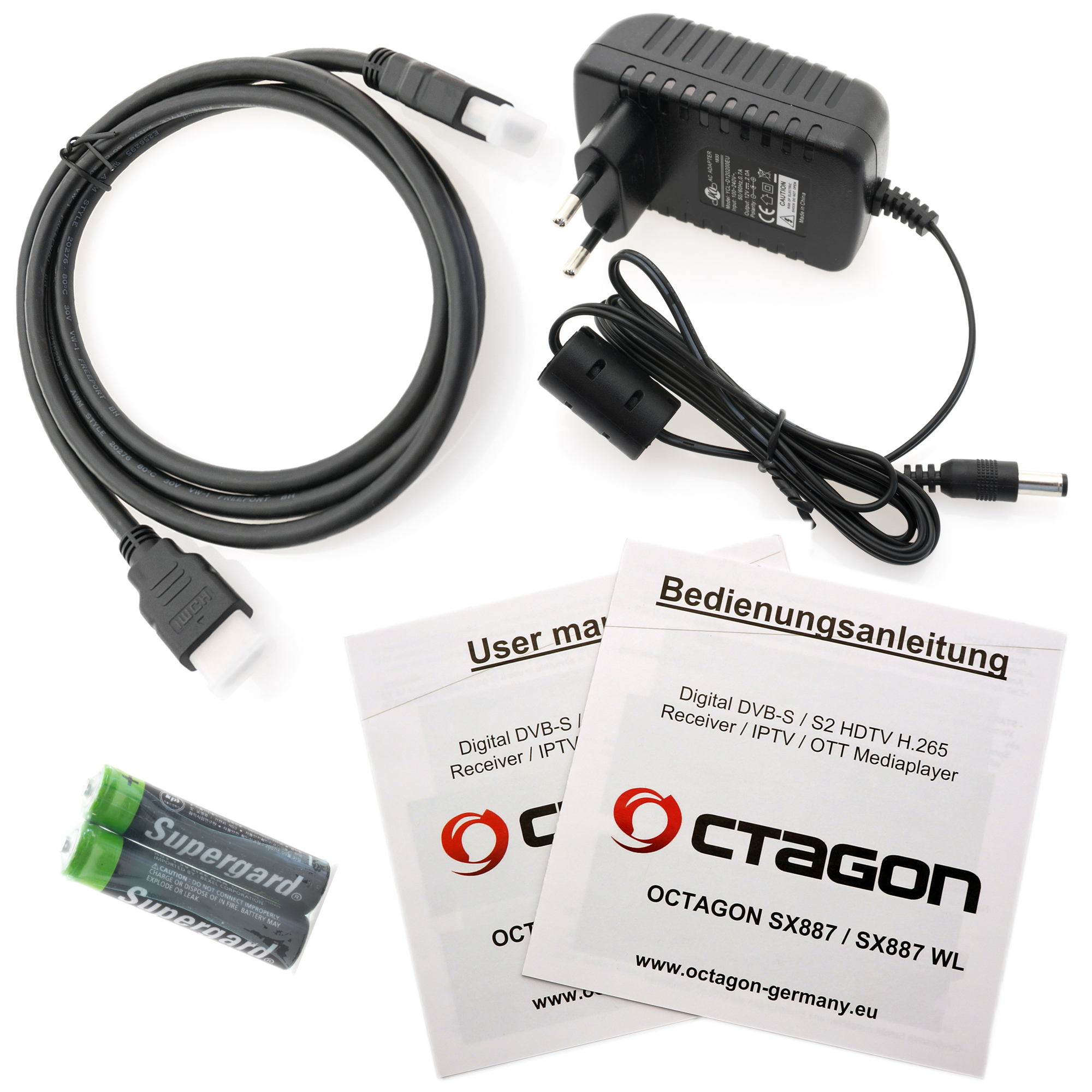Verschiedenes elektronisches Zubehör, darunter Kabel, Netzteil und Handbücher.