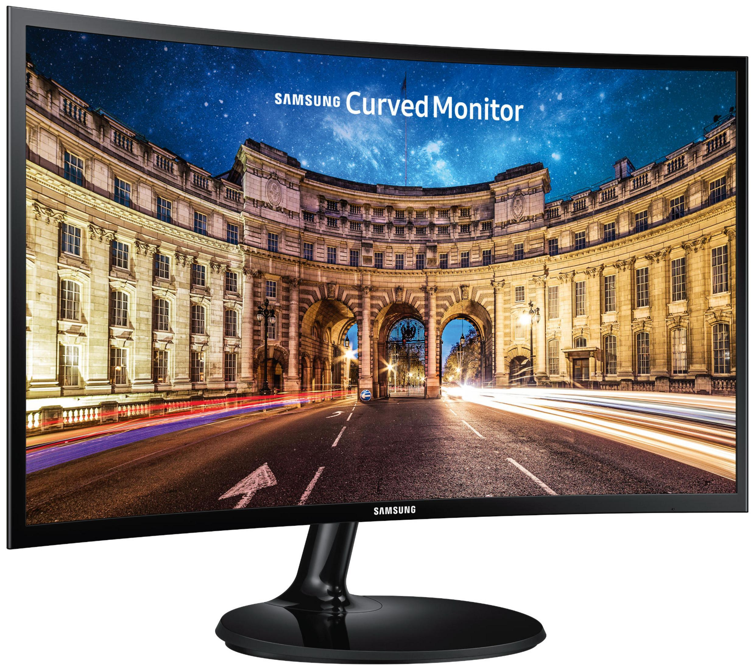 Monitor Samsung nero curvo che mostra una scena notturna con luci della città e cielo stellato.
