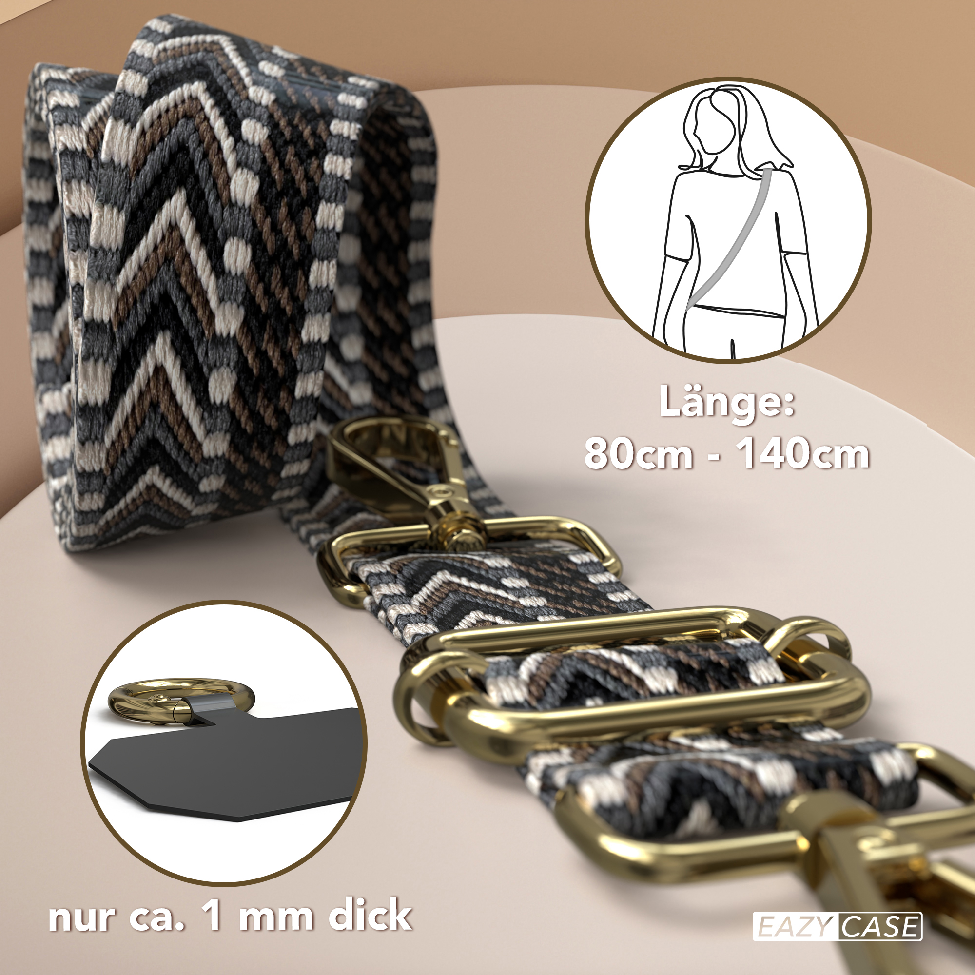 Stoff-Schulterriemen mit geometrischem Muster und goldfarbenen Verschlüssen. Text: 80cm-140cm. Nahaufnahme des schwarzen Tabs.