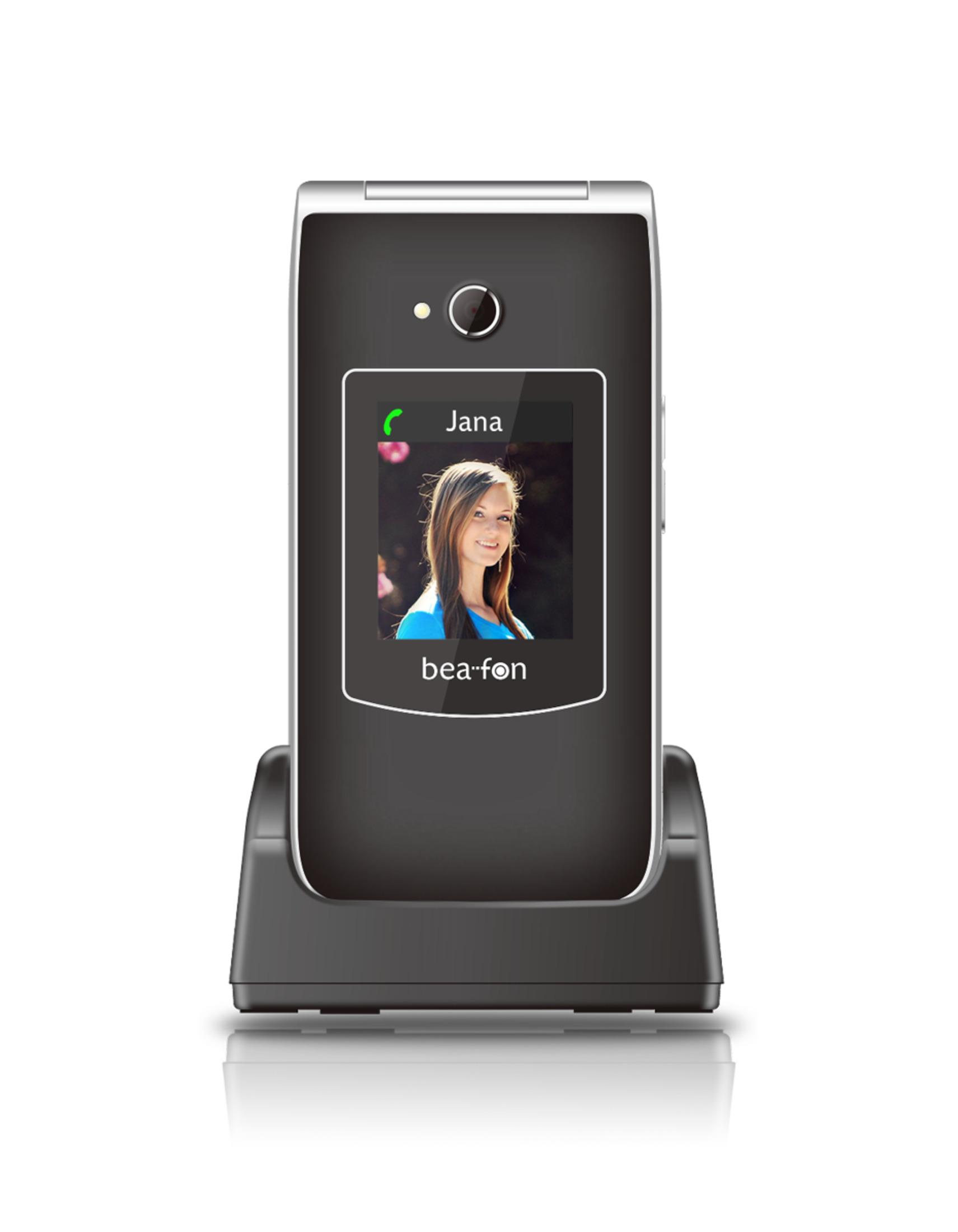 Teléfono plegable negro en un soporte. Pantalla muestra una llamada de Jana, con bea-fon debajo.