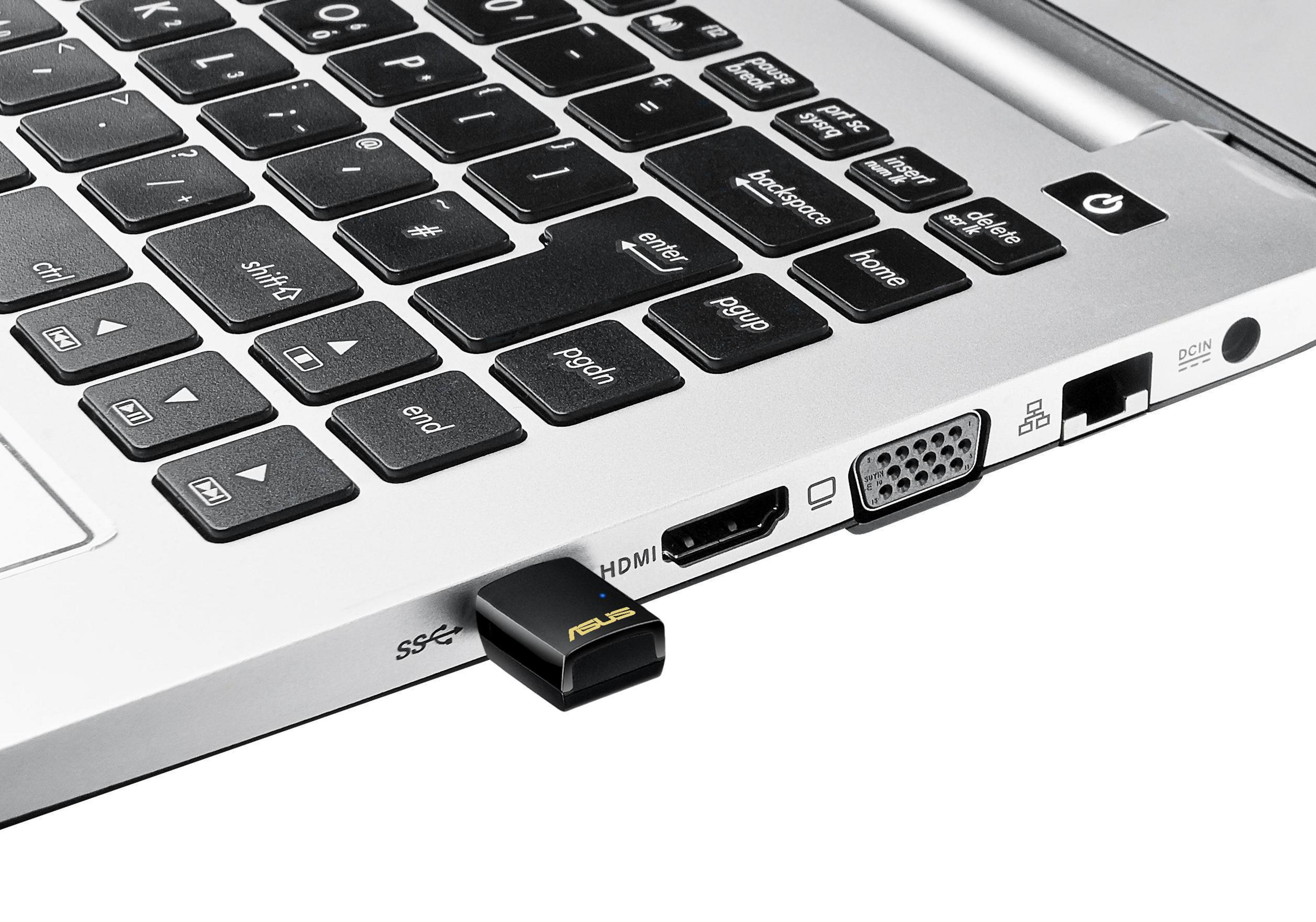 Adaptador USB-A a USB-C conectado al lateral de un portátil.