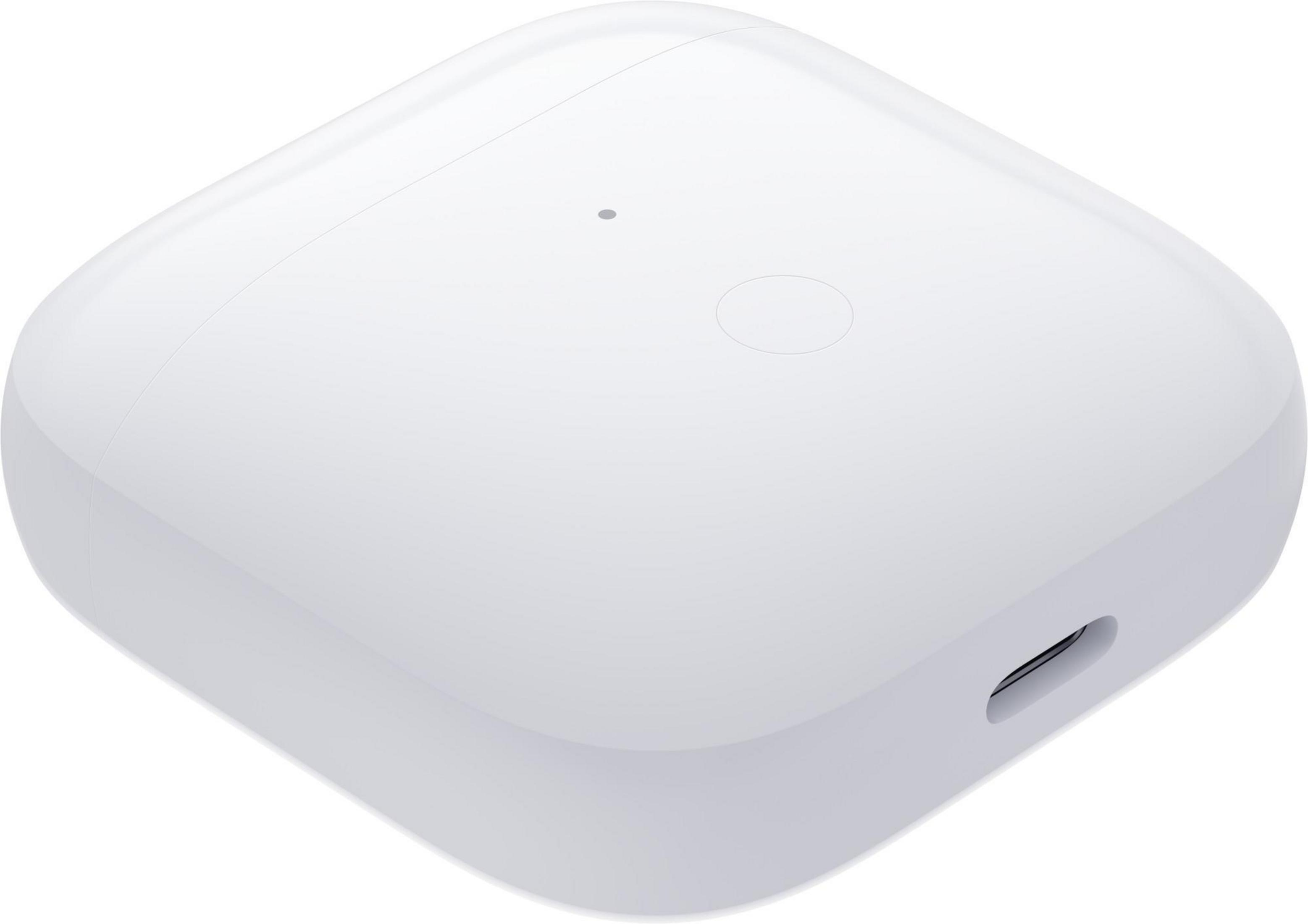 Dispositivo cuadrado blanco. Tiene un puerto de carga y un pequeño punto en la parte superior.