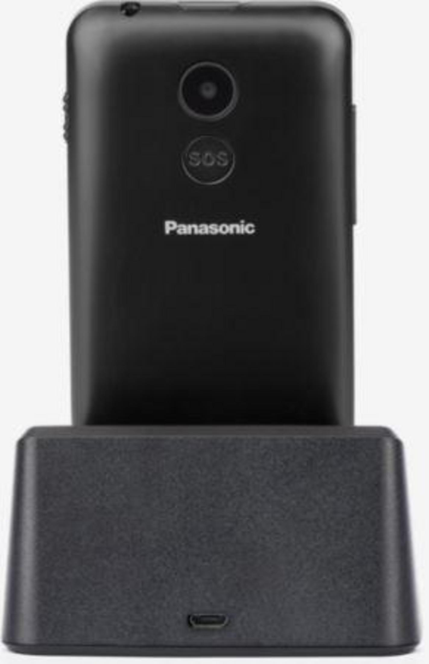 Czarny telefon z przyciskiem SOS na stacji ładującej. Marka to Panasonic.