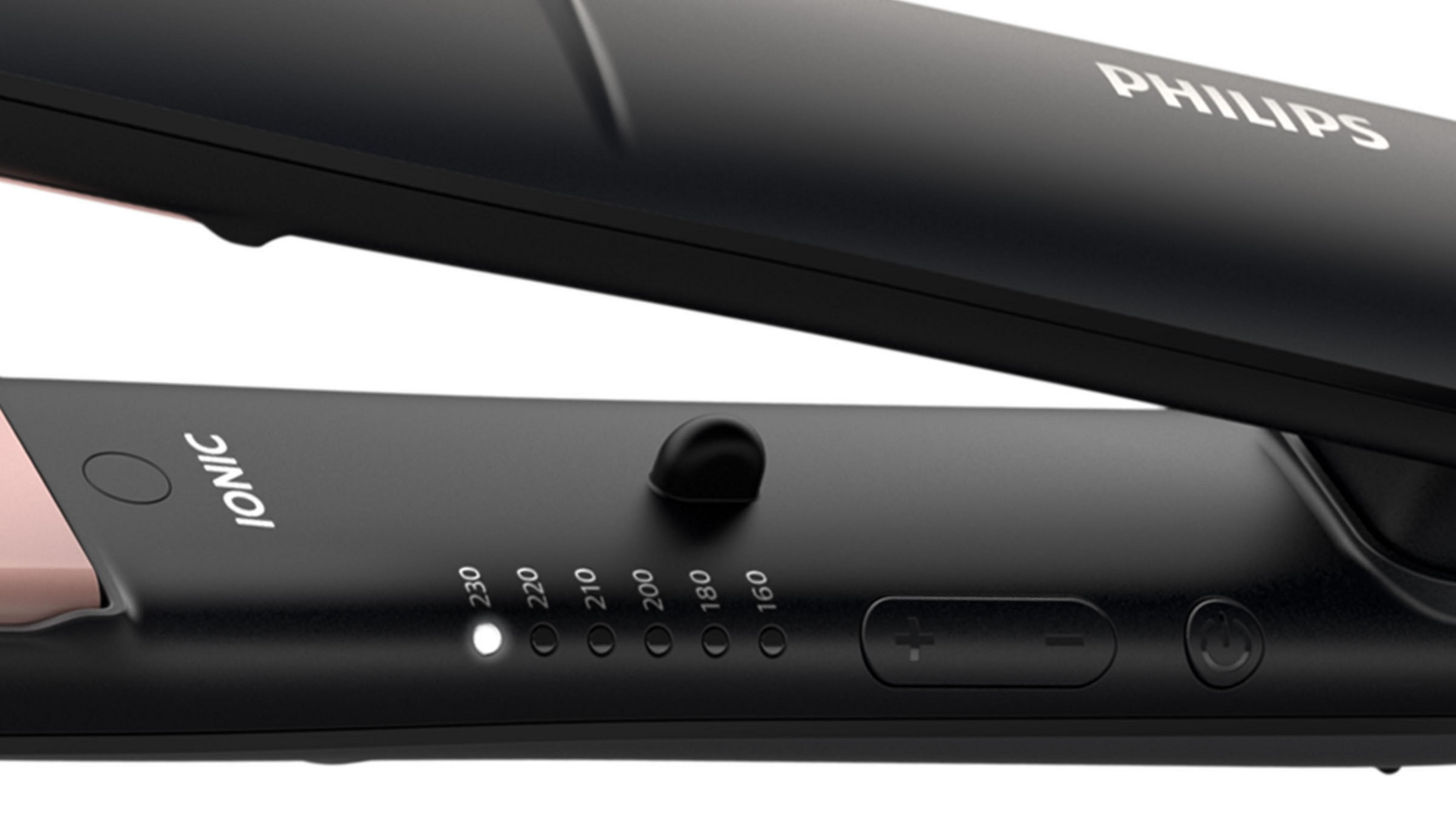 Czarna i różowa prostownica do włosów z ustawieniami temperatury. Białe tło.