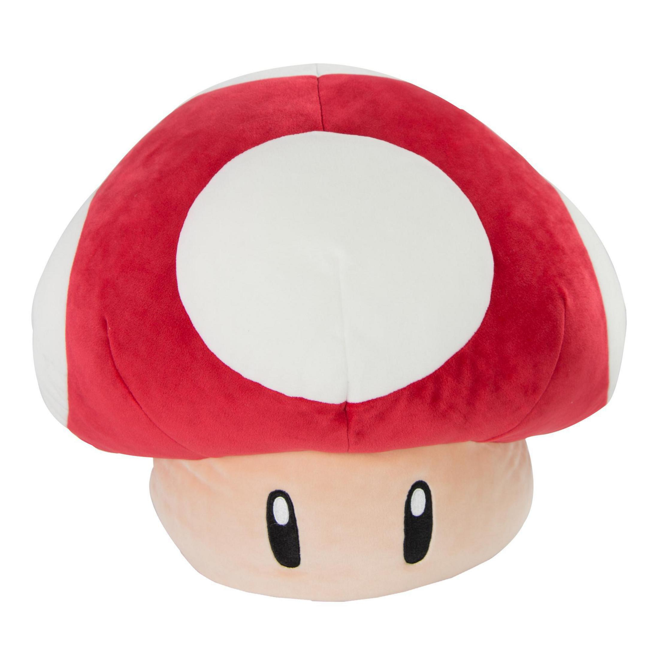 Un giocattolo a forma di fungo di peluche con cappello rosso e pois bianchi. Ha un gambo beige e occhi neri.