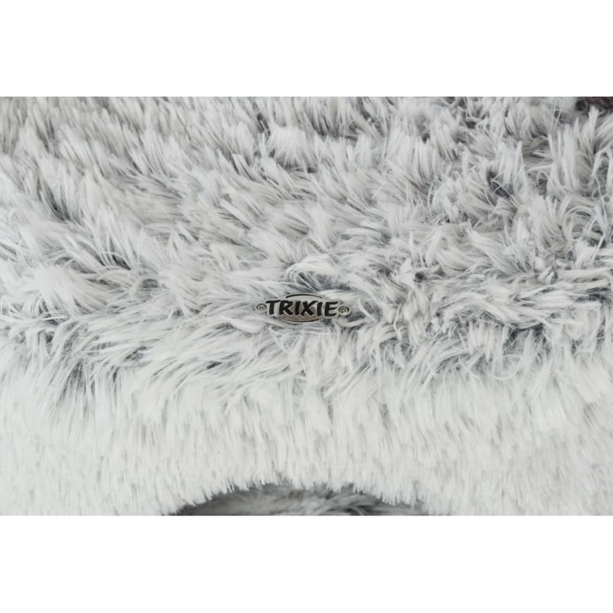 Un letto bianco e soffice per animali domestici con la scritta 'TRIXIE' sulla superficie.