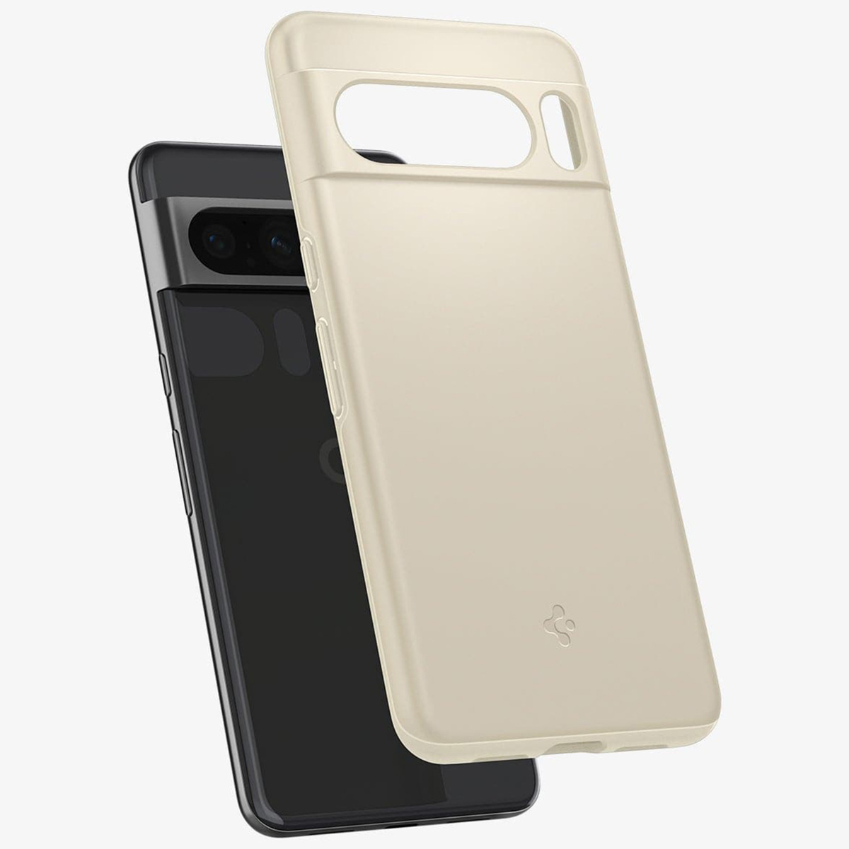 Coque de téléphone crème et un téléphone noir. La coque est ouverte à droite.