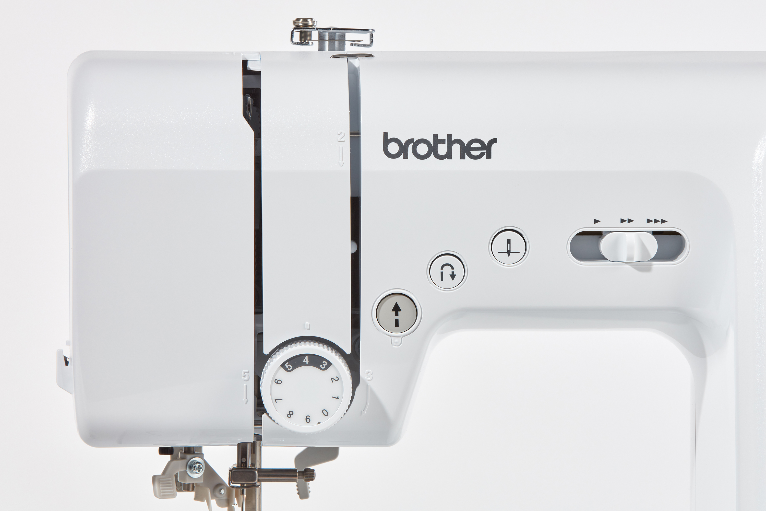 Primer plano de una máquina de coser blanca. El logotipo de Brother es visible.