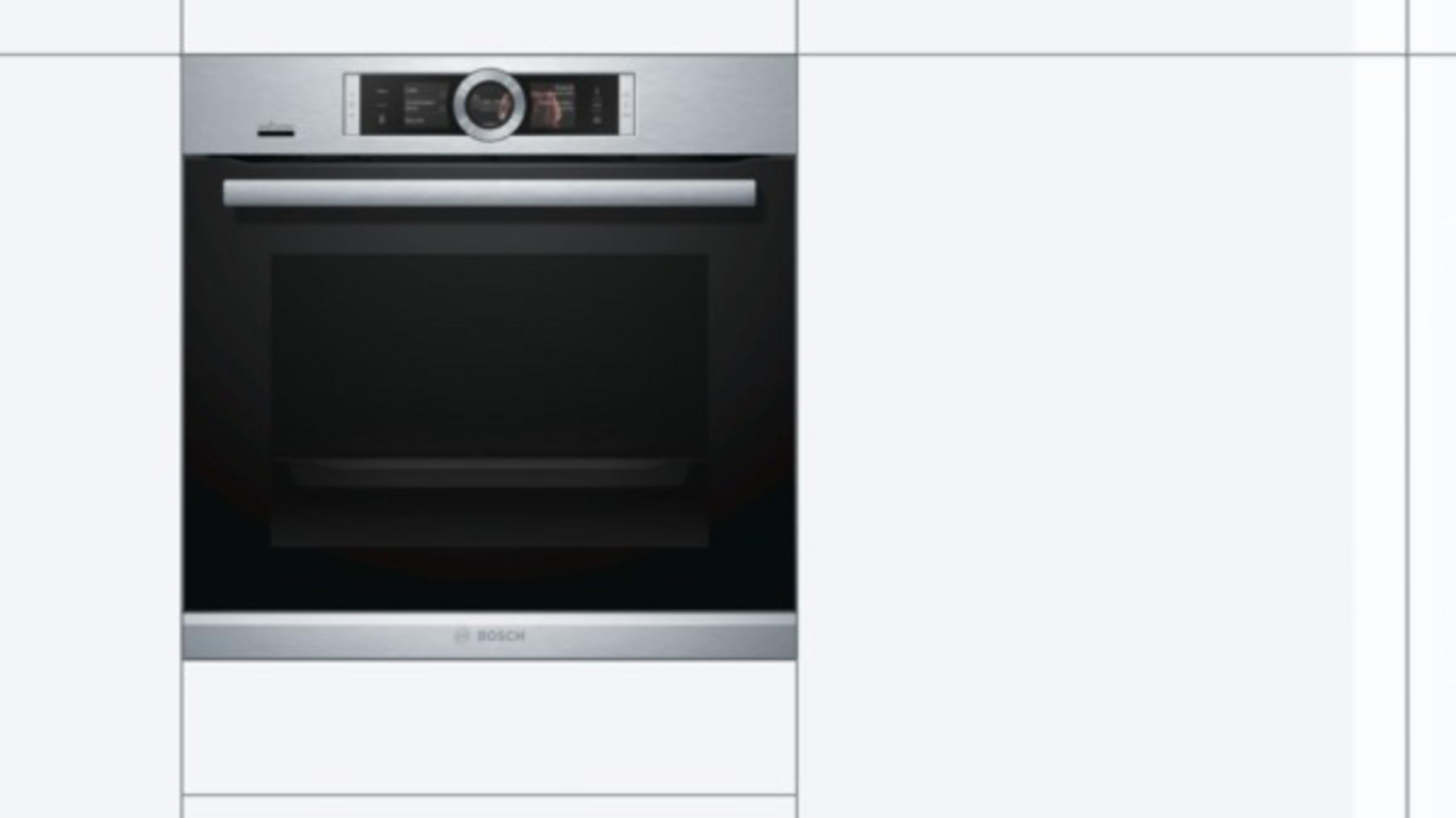 Silver built-in oven with a black door. It is installed in a white kitchen cabinet.