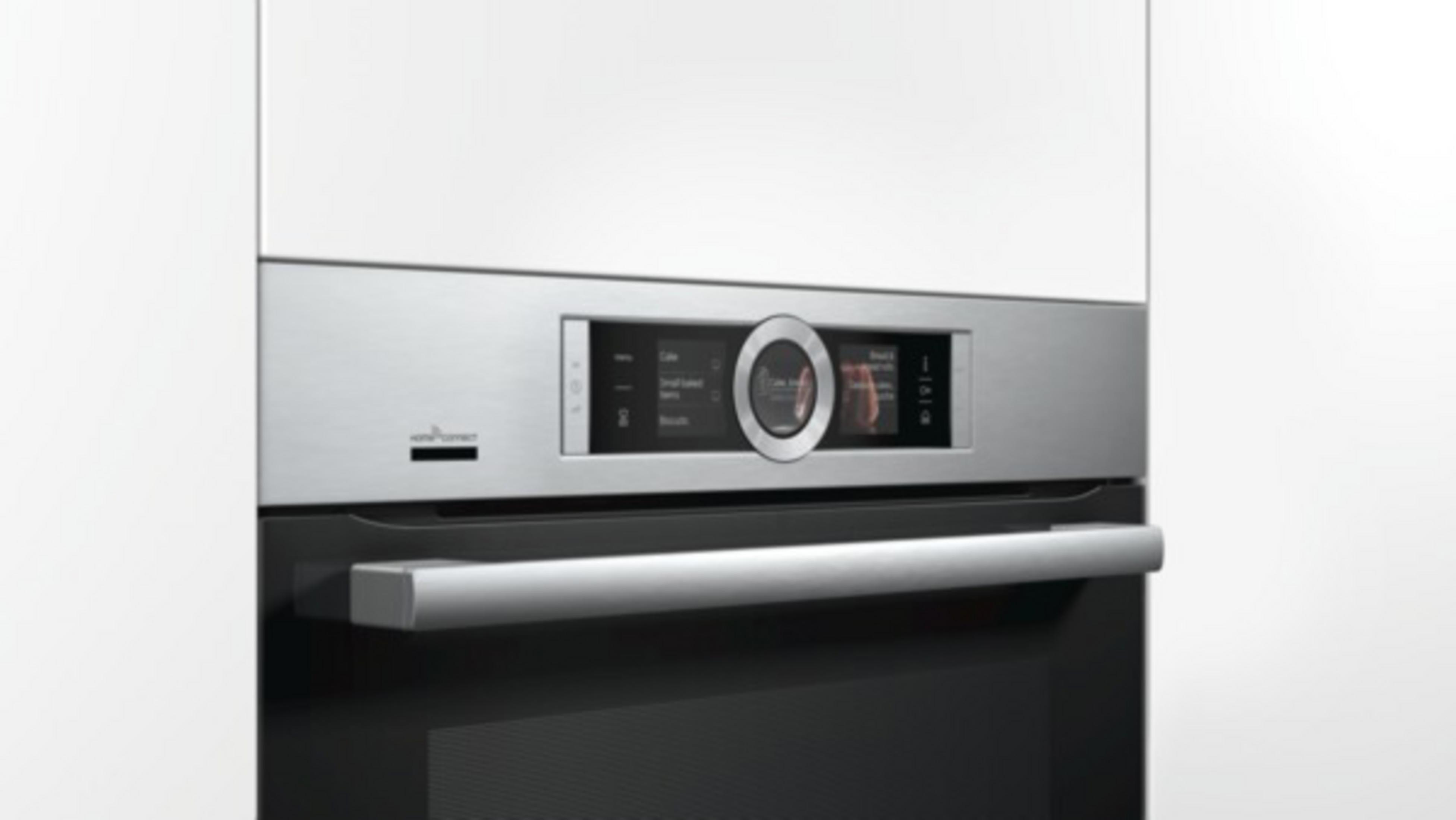 Stainless steel oven front with a control panel displaying a screen.