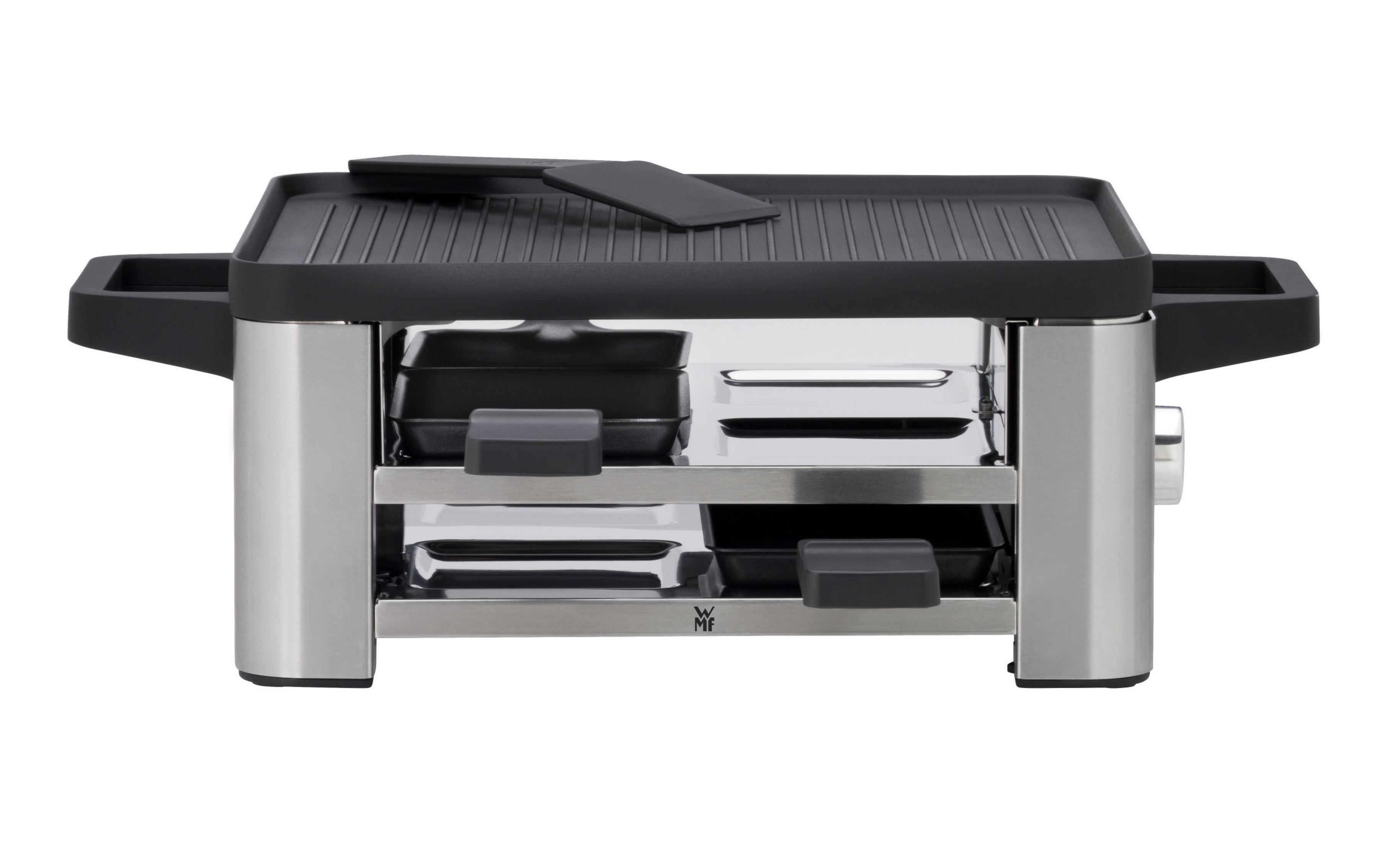 Grill do raclette ze stali nierdzewnej z czarną powierzchnią do gotowania i tacami. Dwie szpatułki na górze.