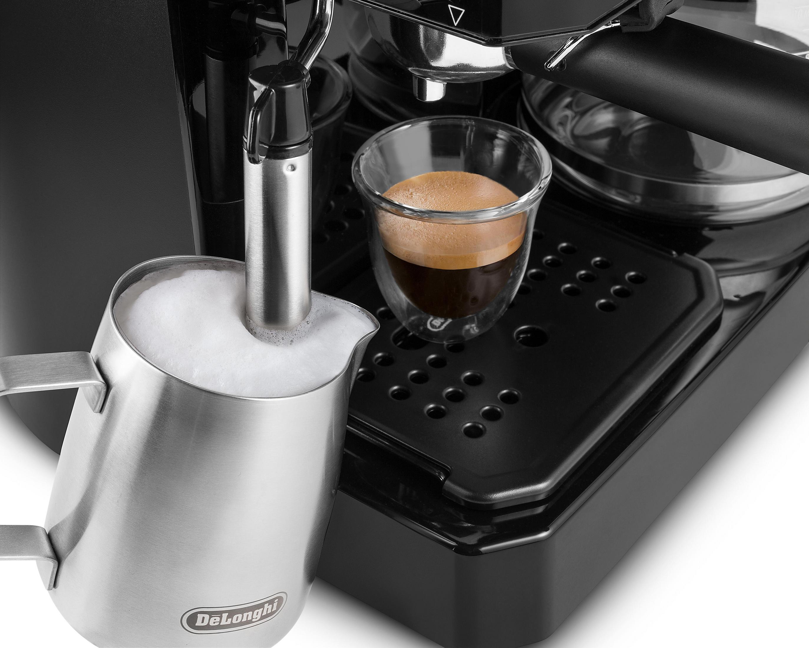 Espressomaschine, die Milch aufschäumt. Auf der rechten Seite befindet sich ein Glas mit Espresso.