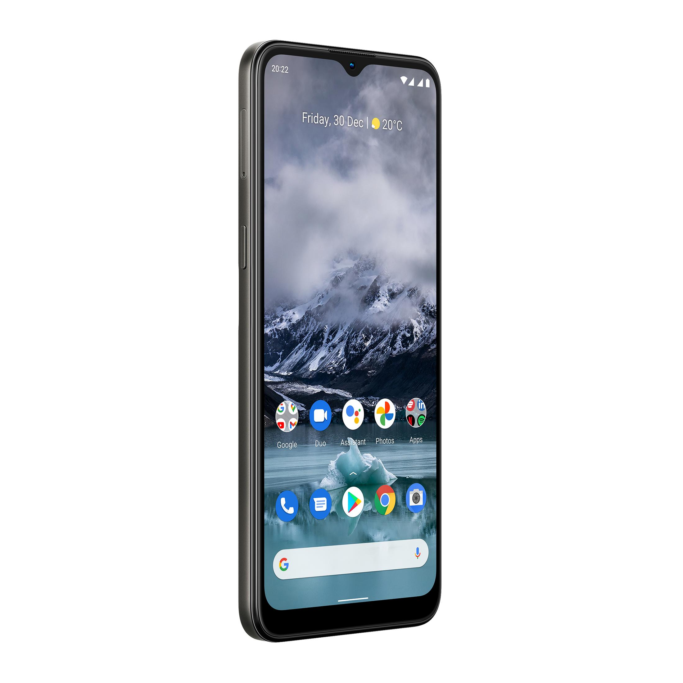 Smartfon Nokia z godziną, datą i ikonami aplikacji. W tle ośnieżone góry.