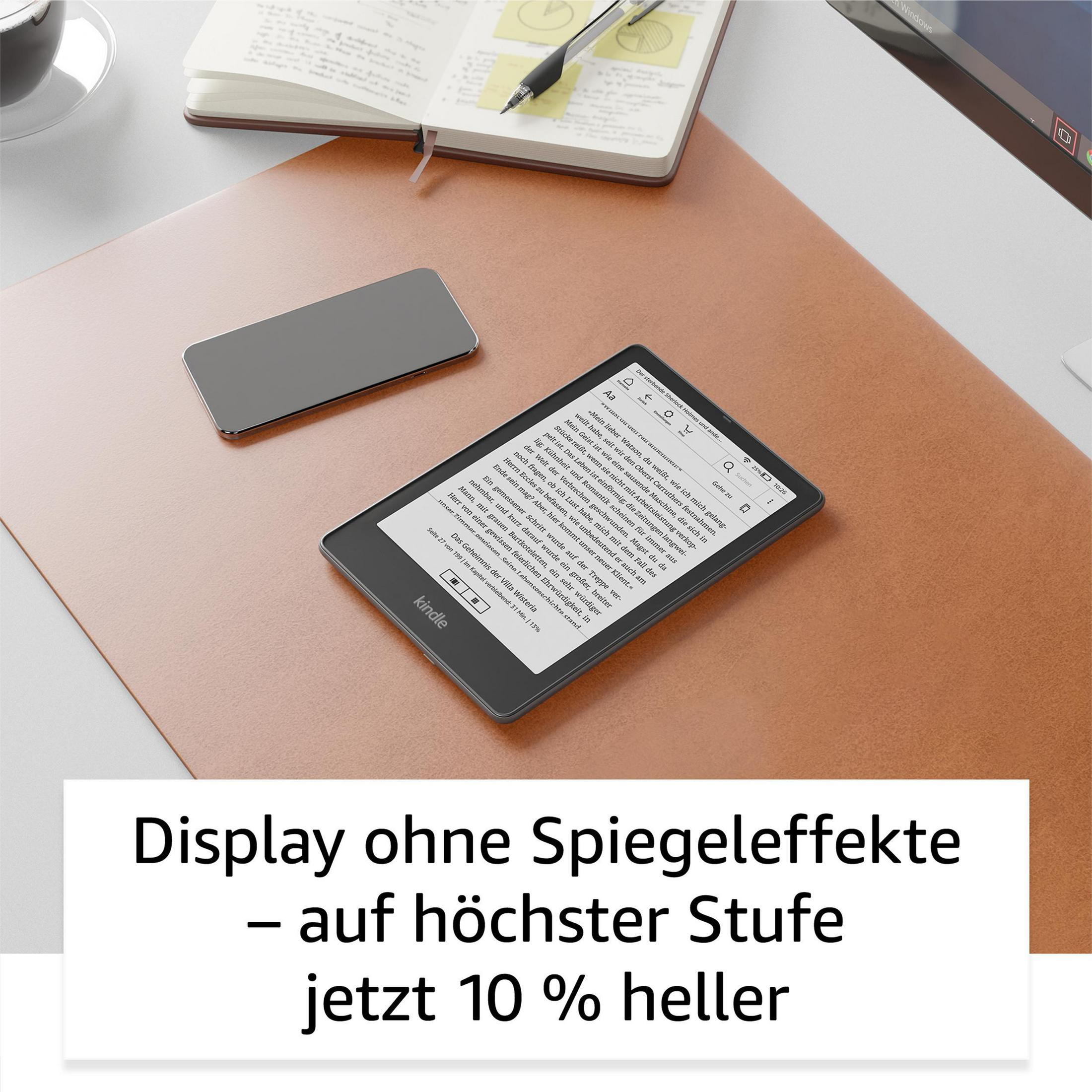E-Reader auf einem Schreibtisch mit Telefon und Notizbuch, mit Text über das Display.