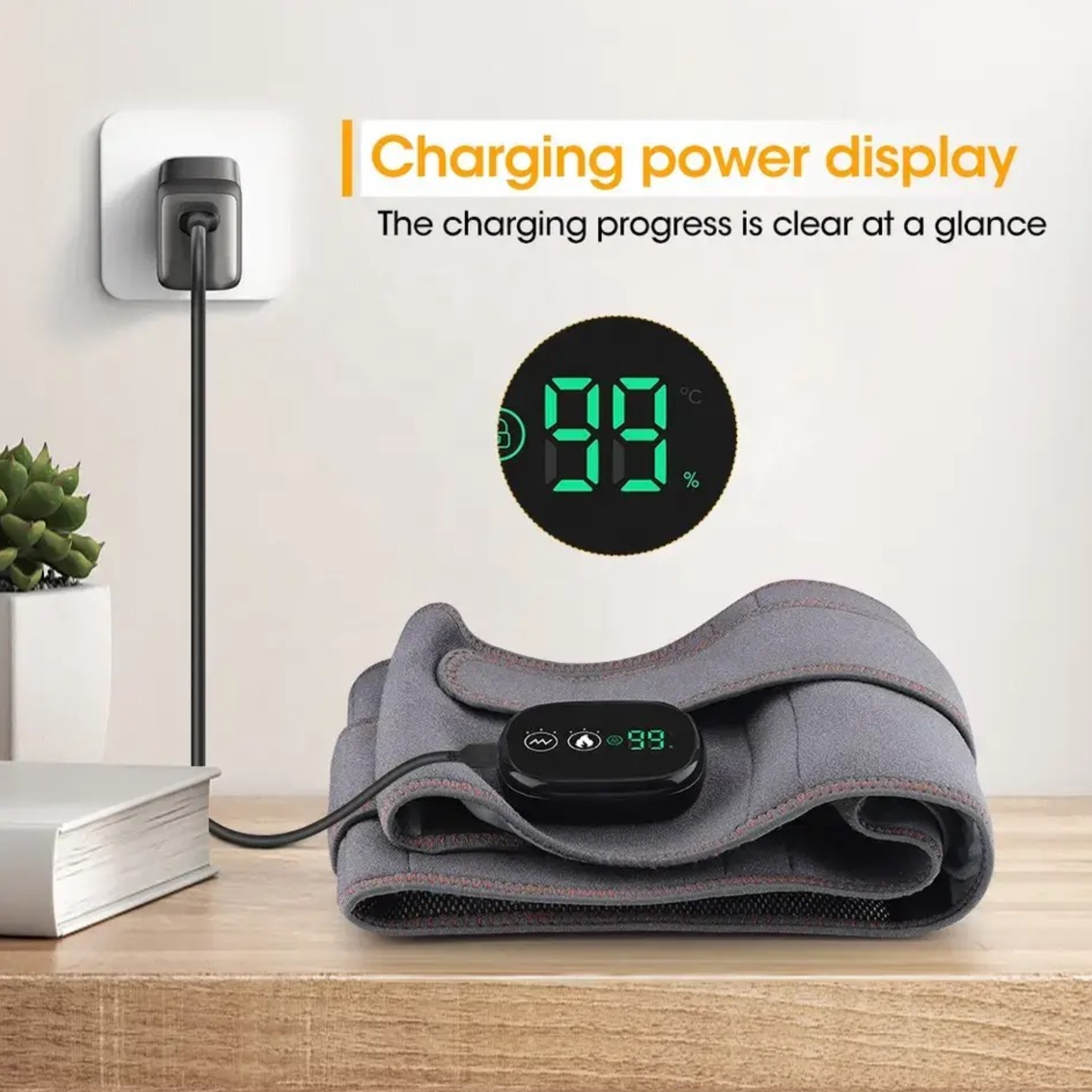 Szara poduszka grzewcza podłączona do ściany. Wyświetlacz pokazuje 99%. Obecny jest czarny przycisk zasilania.