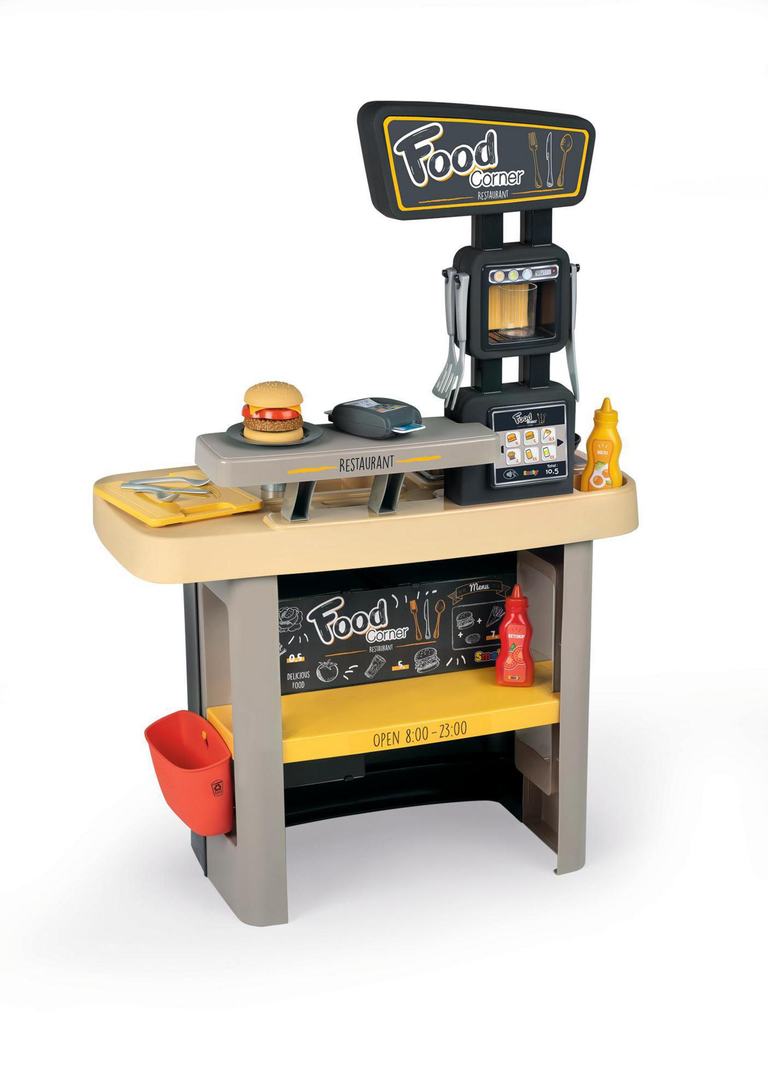 Zabawkowy kącik gastronomiczny z menu, kasą i burgerem. Białe tło.