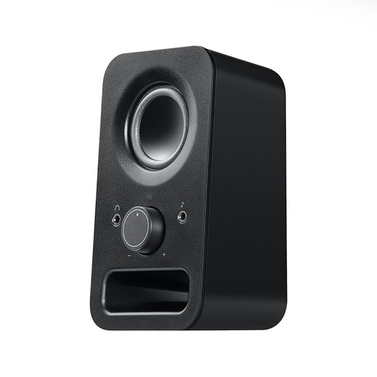 Un altavoz compacto negro con un altavoz redondo y controles de volumen en la parte delantera, fondo blanco.