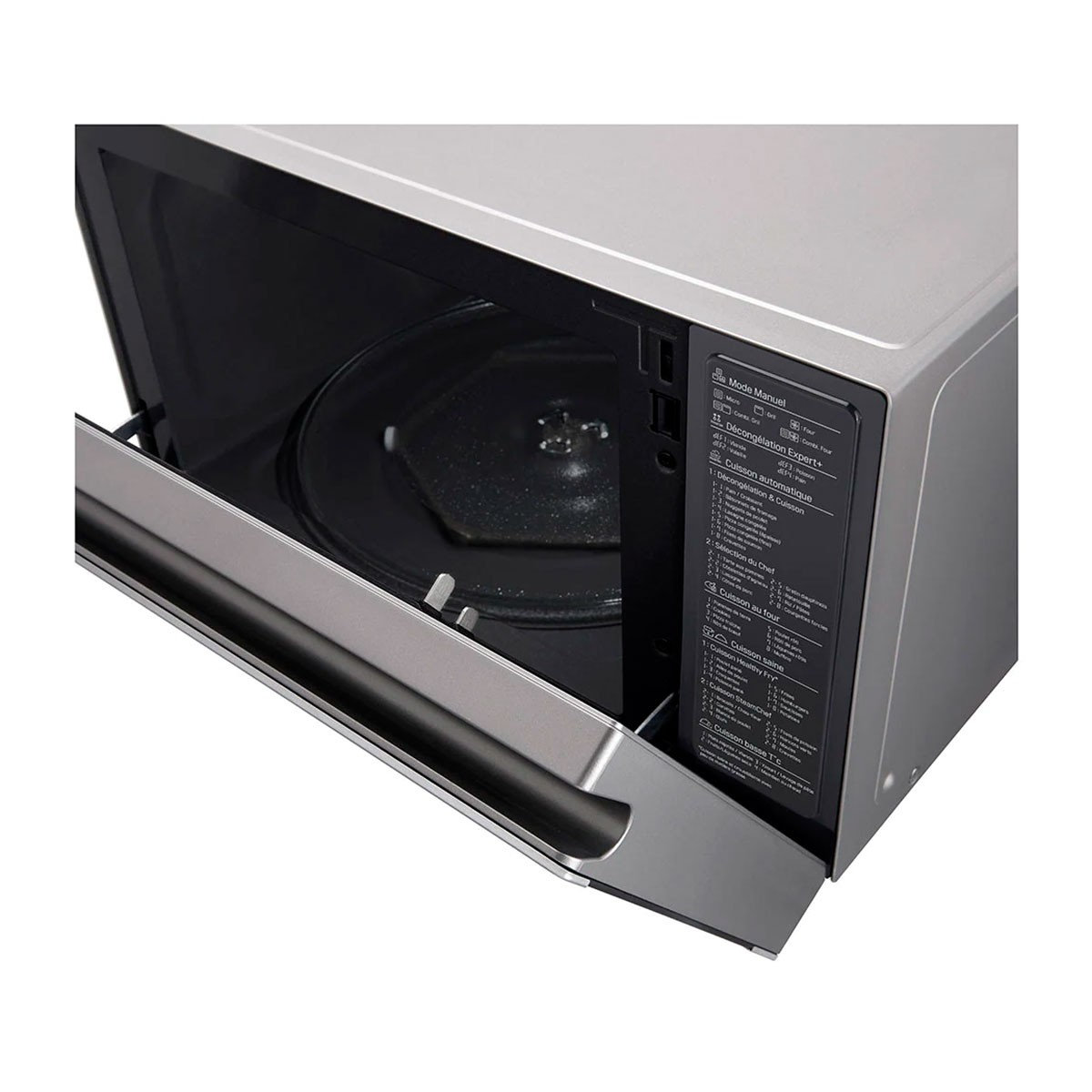 Srebrna kuchenka mikrofalowa z otwartymi drzwiami. Wewnątrz znajduje się szklany talerz.