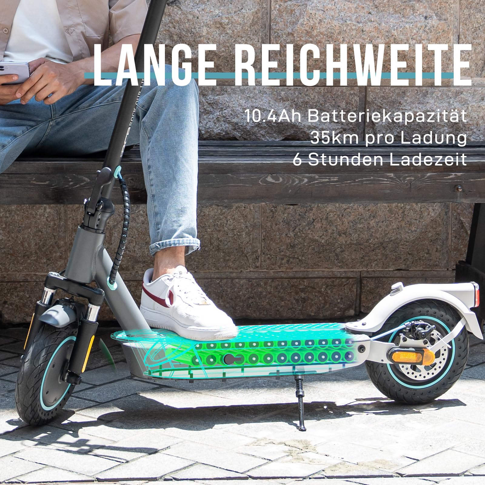 Osoba na skuterze trzymająca telefon. Skuter ma akumulator 10,4 Ah i przejeżdża 35 km na jednym ładowaniu.