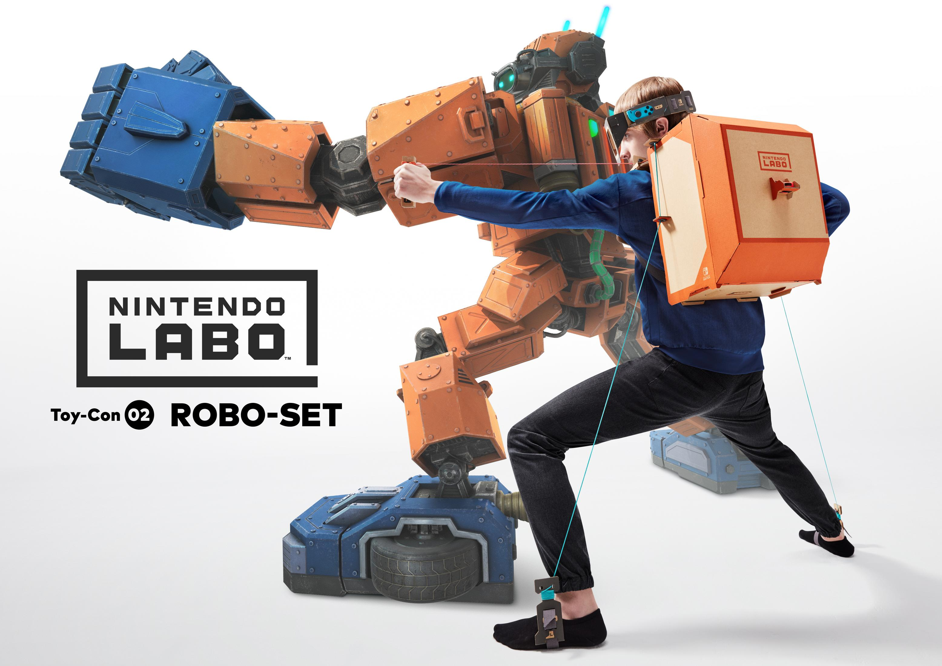 Osoba z zestawem VR kontroluje duże, robotyczne ramię. Widoczne logo Nintendo Labo.