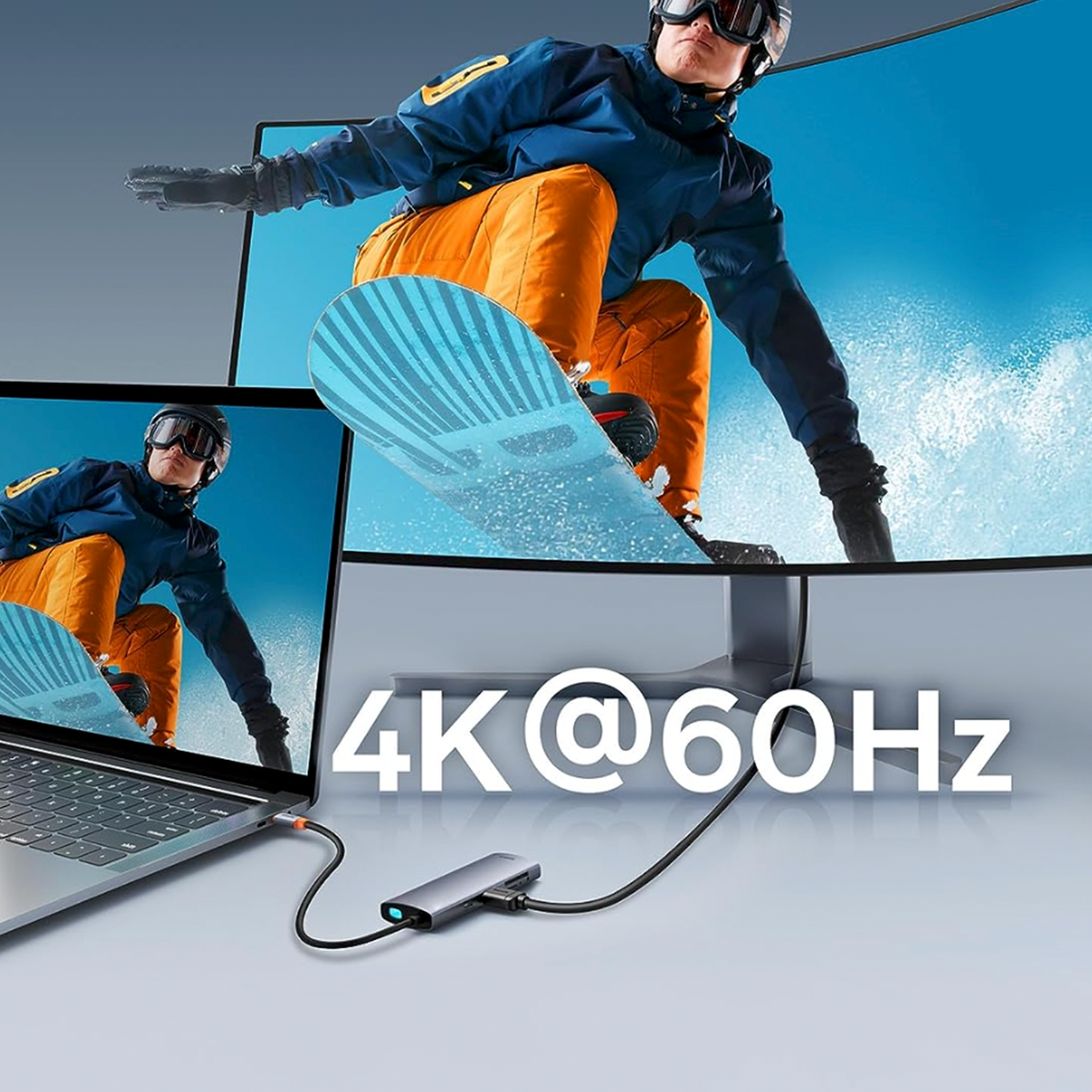 Laptop i dwa monitory wyświetlają narciarza, koncentrator i kabel łączą urządzenia.