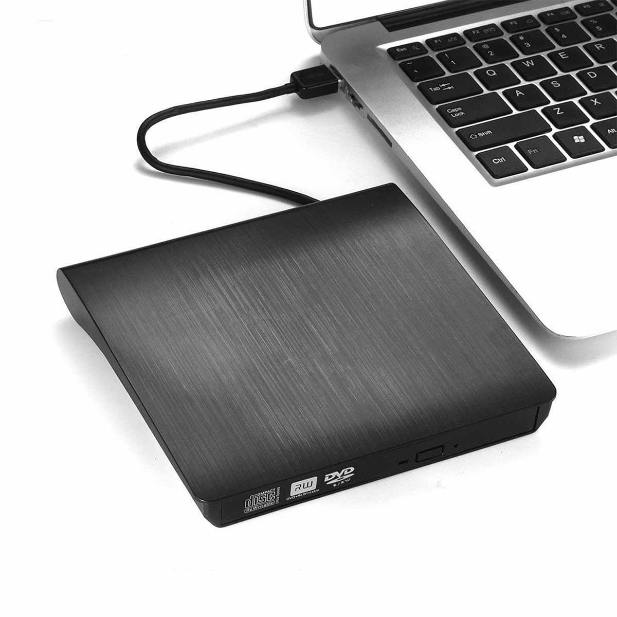 Ein schwarzes externes DVD-Laufwerk, das mit einem Laptop verbunden ist. Der Laptop befindet sich auf einer weißen Oberfläche.