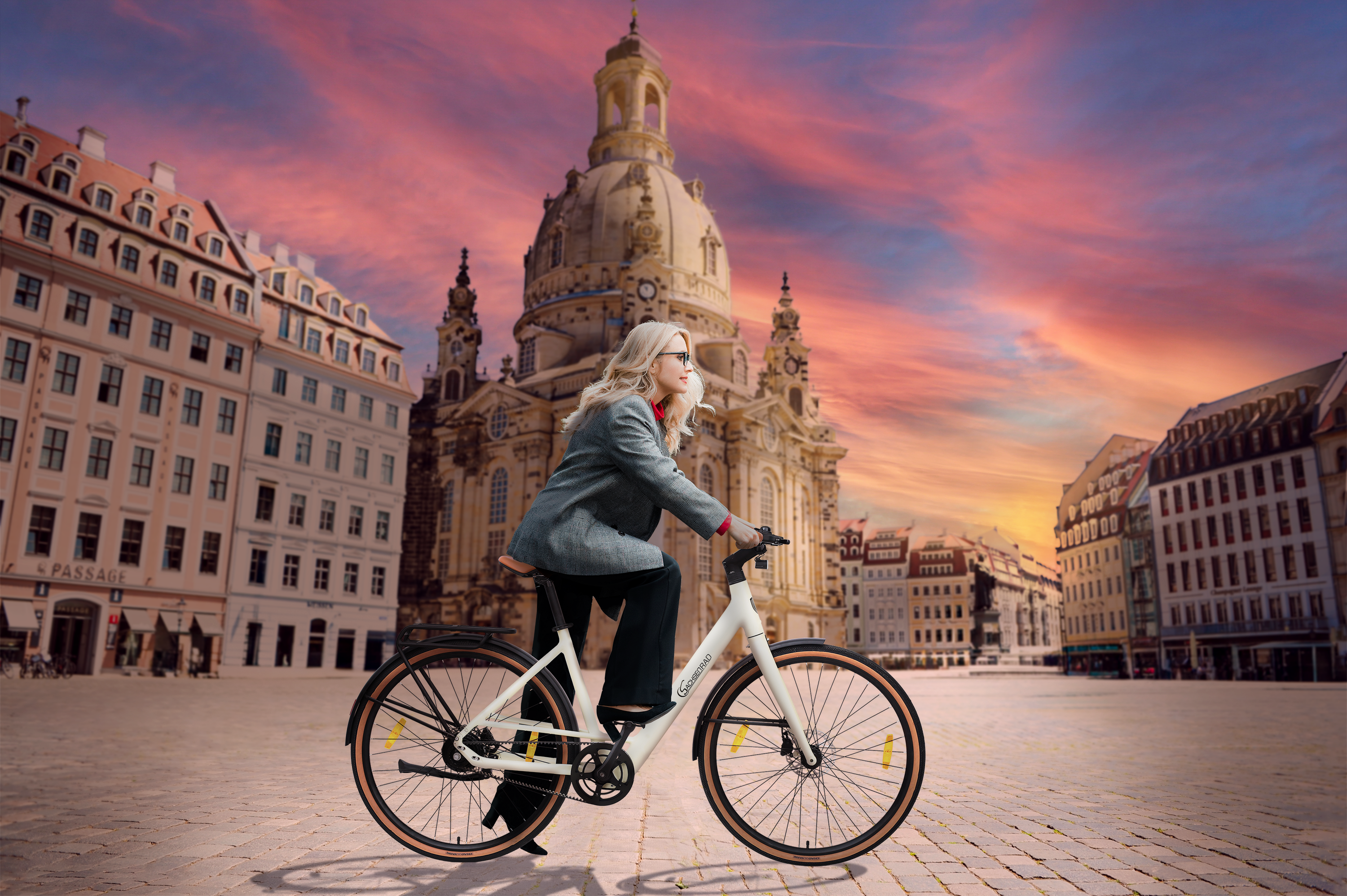 Frau fährt mit weißem Fahrrad in einer Stadt. Der Himmel ist bunt, Gebäude im Hintergrund.