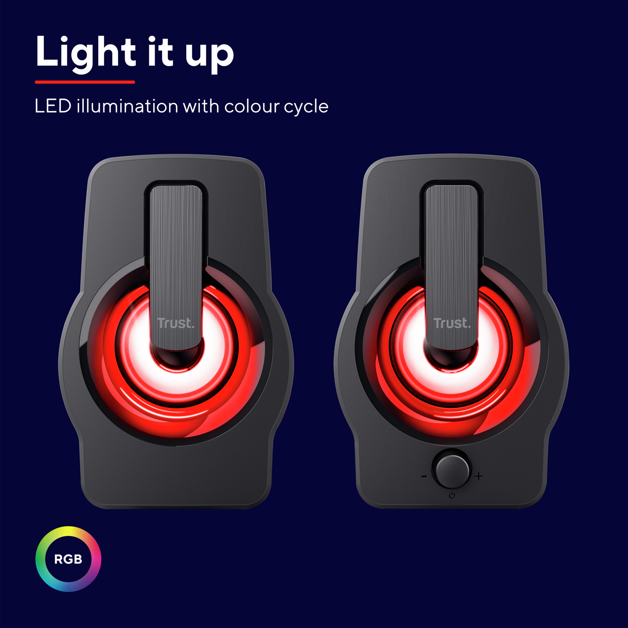 Pair of Trust speakers with RGB lighting. Black color with color cycle. Dark blue background.