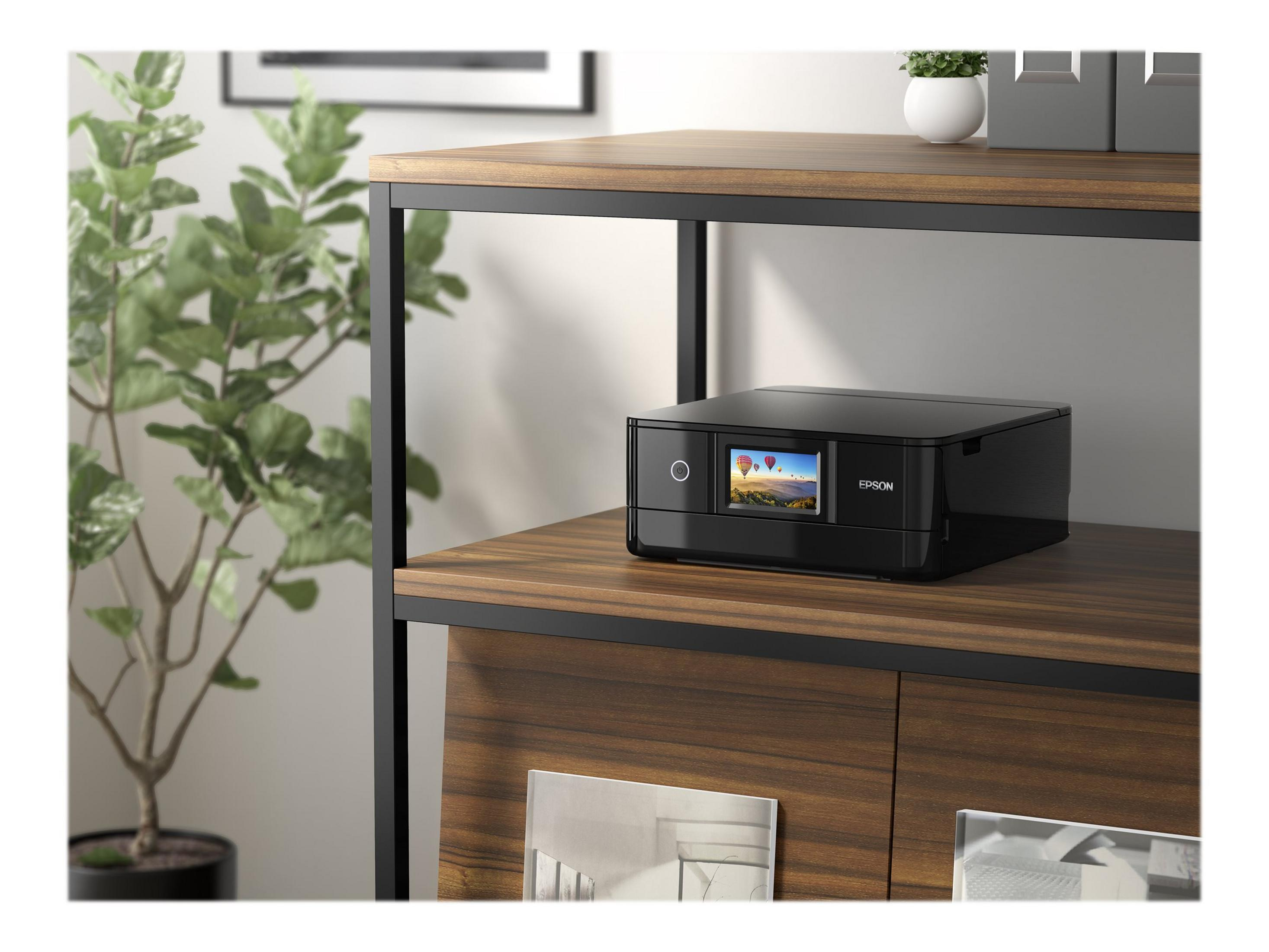 Czarna drukarka Epson na półce. Drukarka ma wyświetlacz. Półka znajduje się na drewnianej szafce.