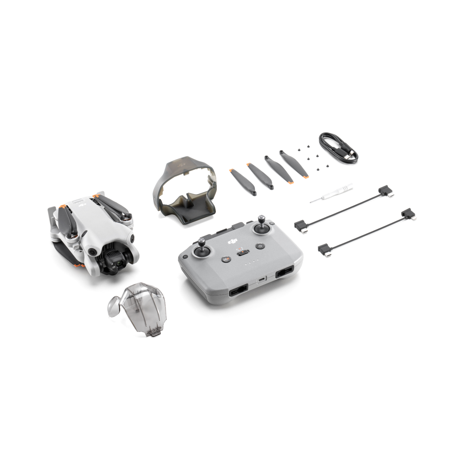 Dron i jego akcesoria są rozłożone. W zestawie pilot, śmigła i futerał.