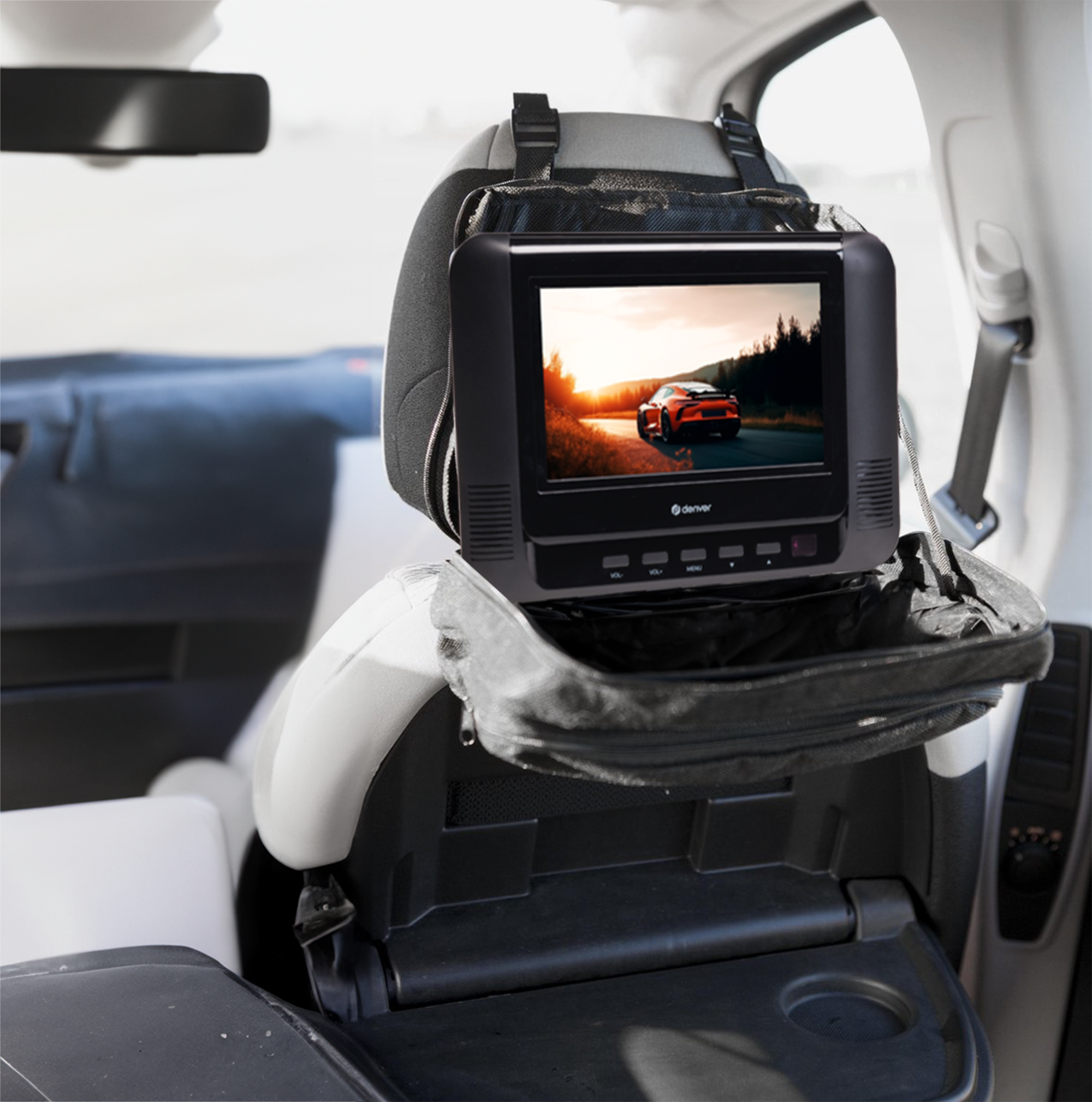 Portable car TV screen showing a car on a road during sunset, mounted on a headrest.