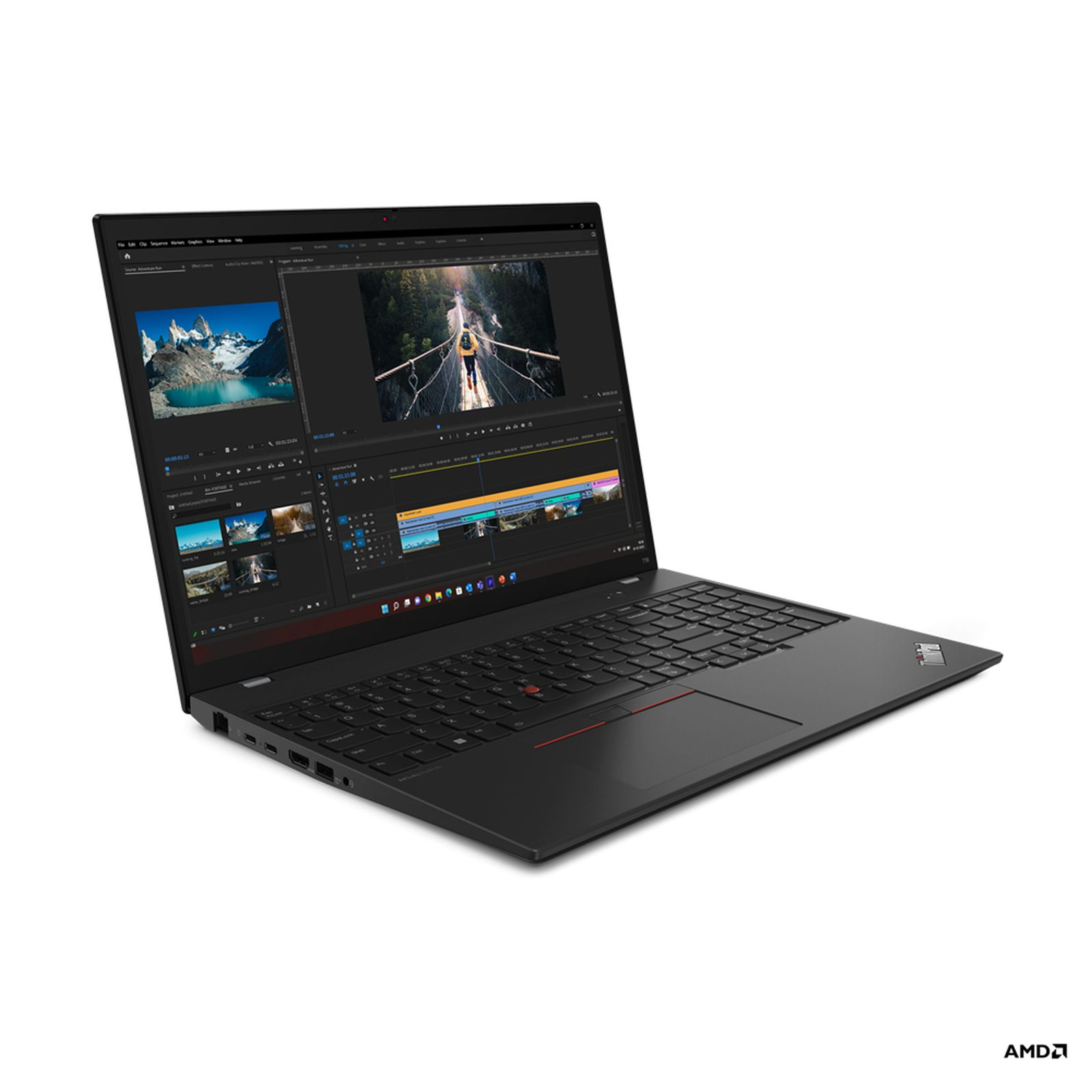 Laptop nero con interfaccia di editing video, con immagini di montagne e una persona su un ponte. Logo AMD.