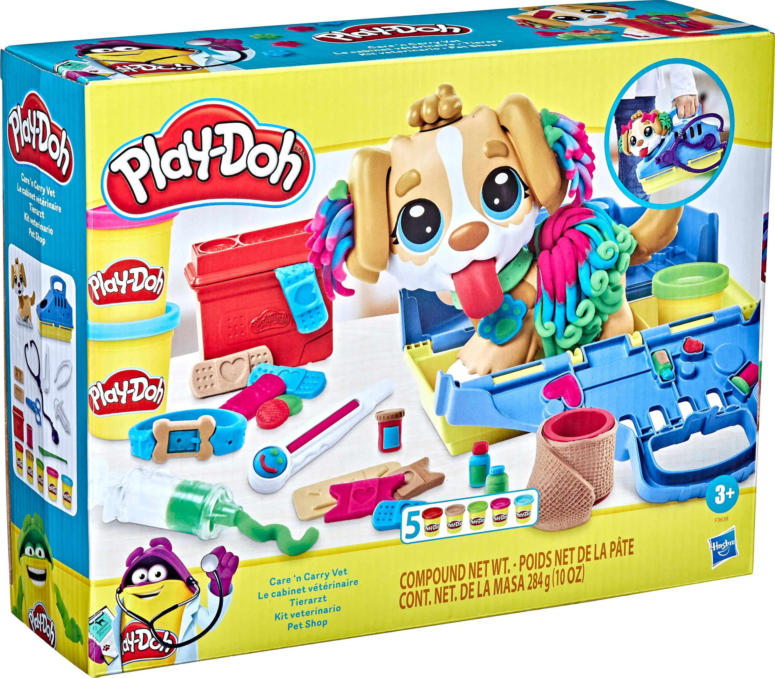 Caja del kit veterinario Play-Doh. Figura de perro, Play-Doh y herramientas veterinarias. Fondo blanco.