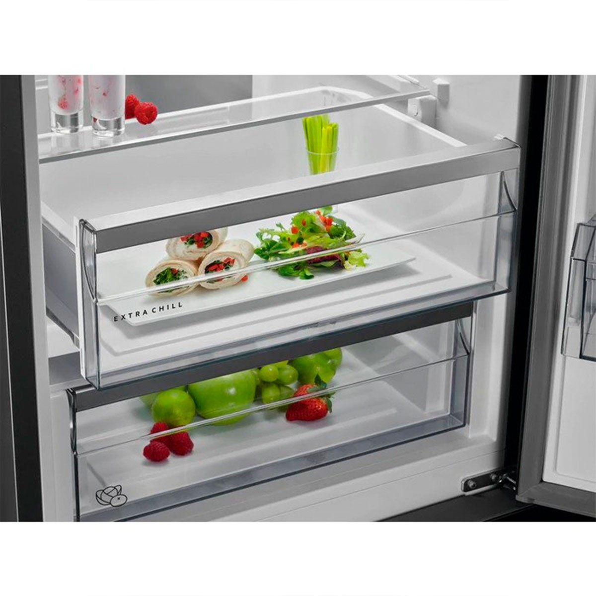 Interior de nevera con cajones transparentes llenos de alimentos.