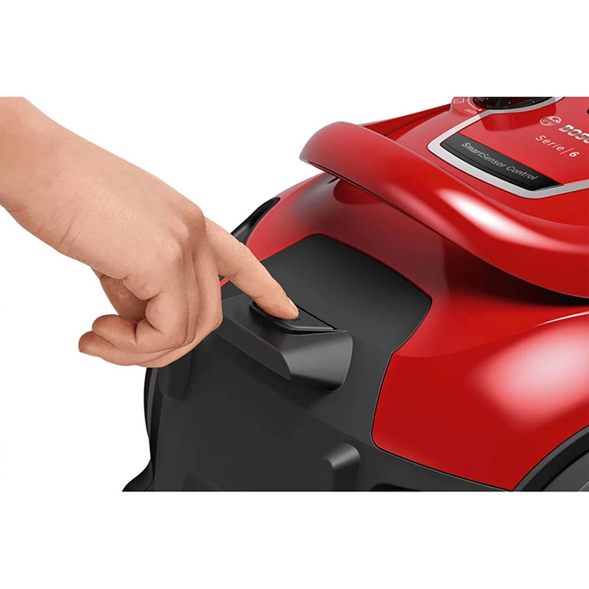 Hand drukt op een knop op een rode stofzuiger, met het label serie 6.