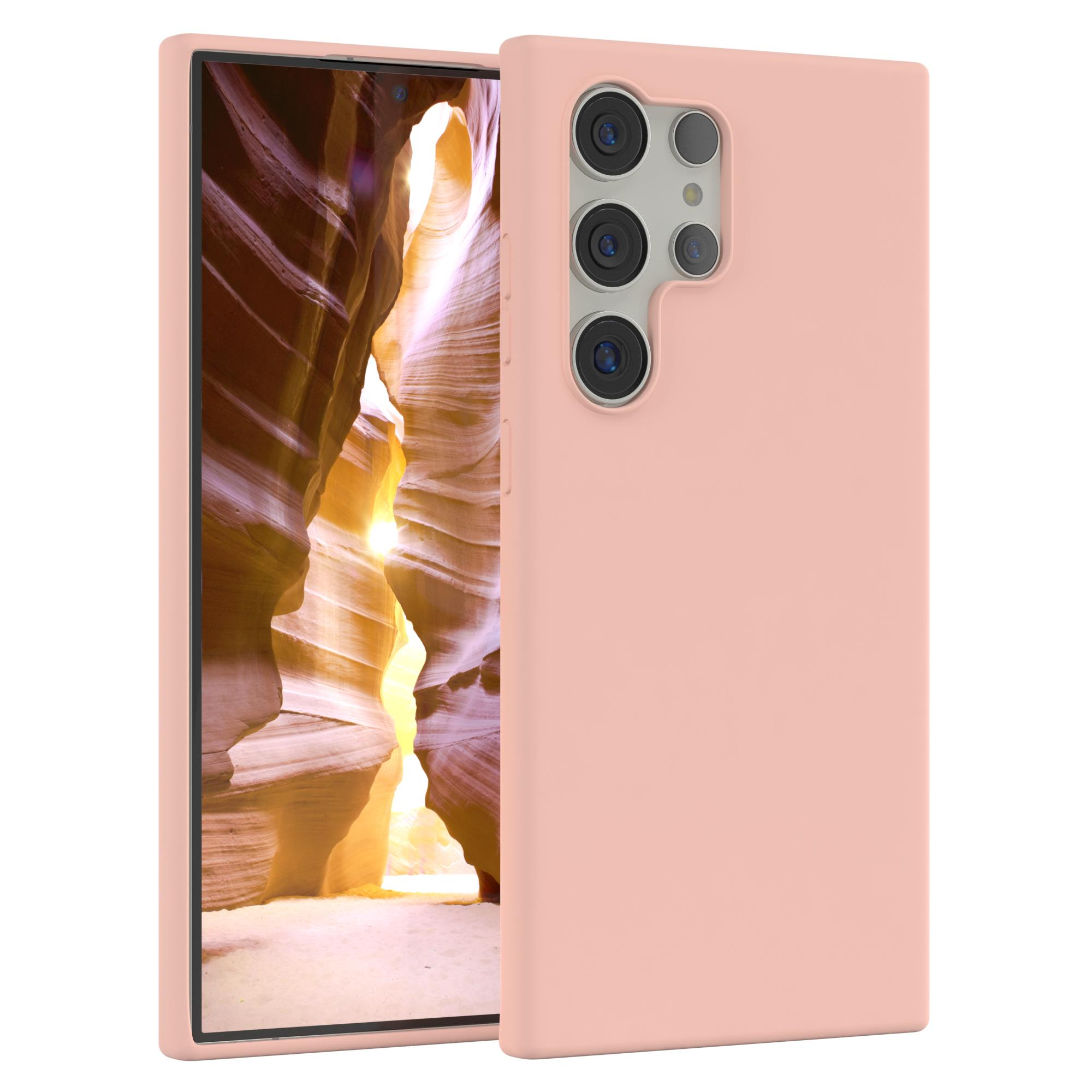 Eine rosa Handyhülle mit einem Telefon darin. Der Hintergrund ist eine Canyonszene.