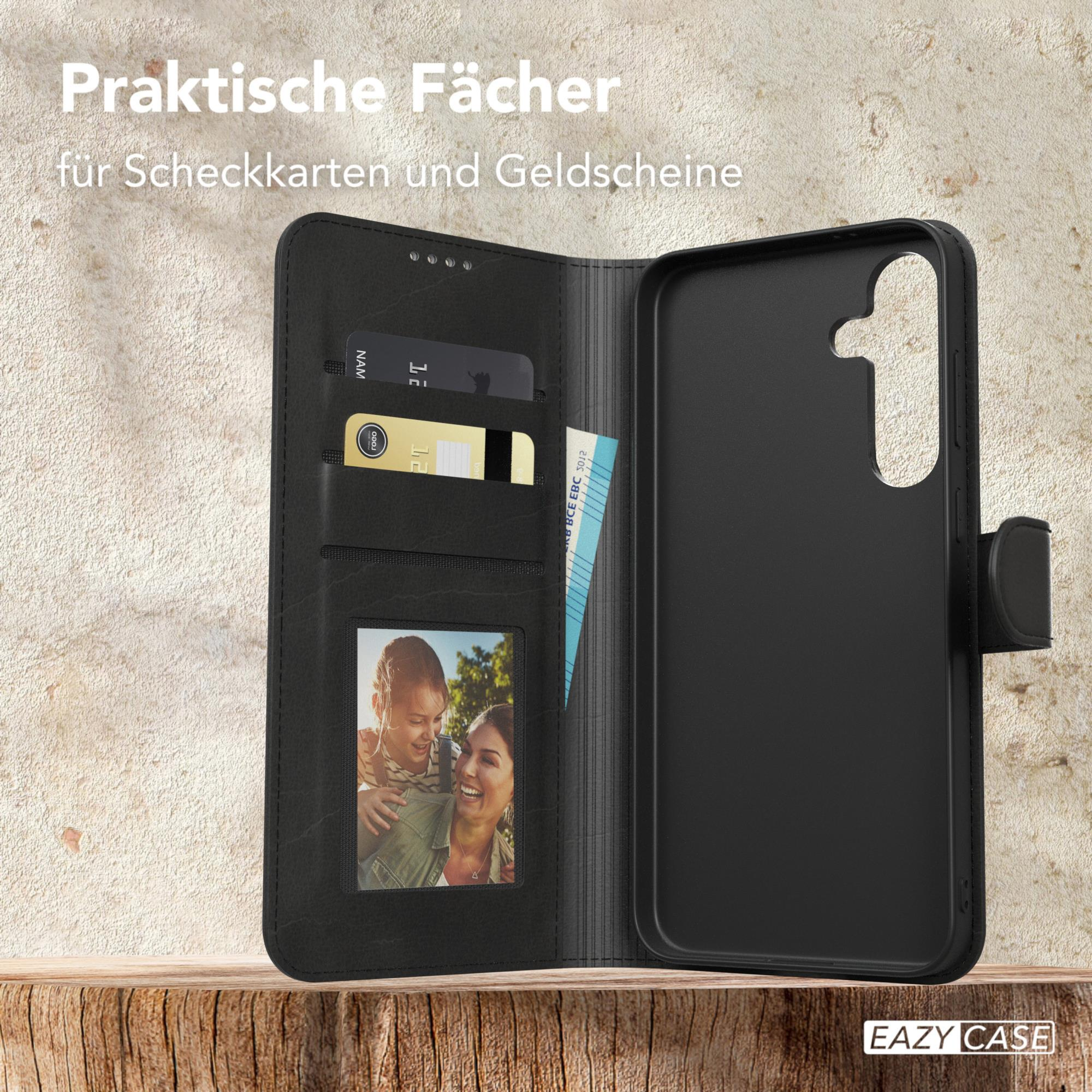 Schwarze Handyhülle geöffnet, mit Kartenfächern, einem Fotoschacht und einer Geldbörse. Text: Praktische Fächer.